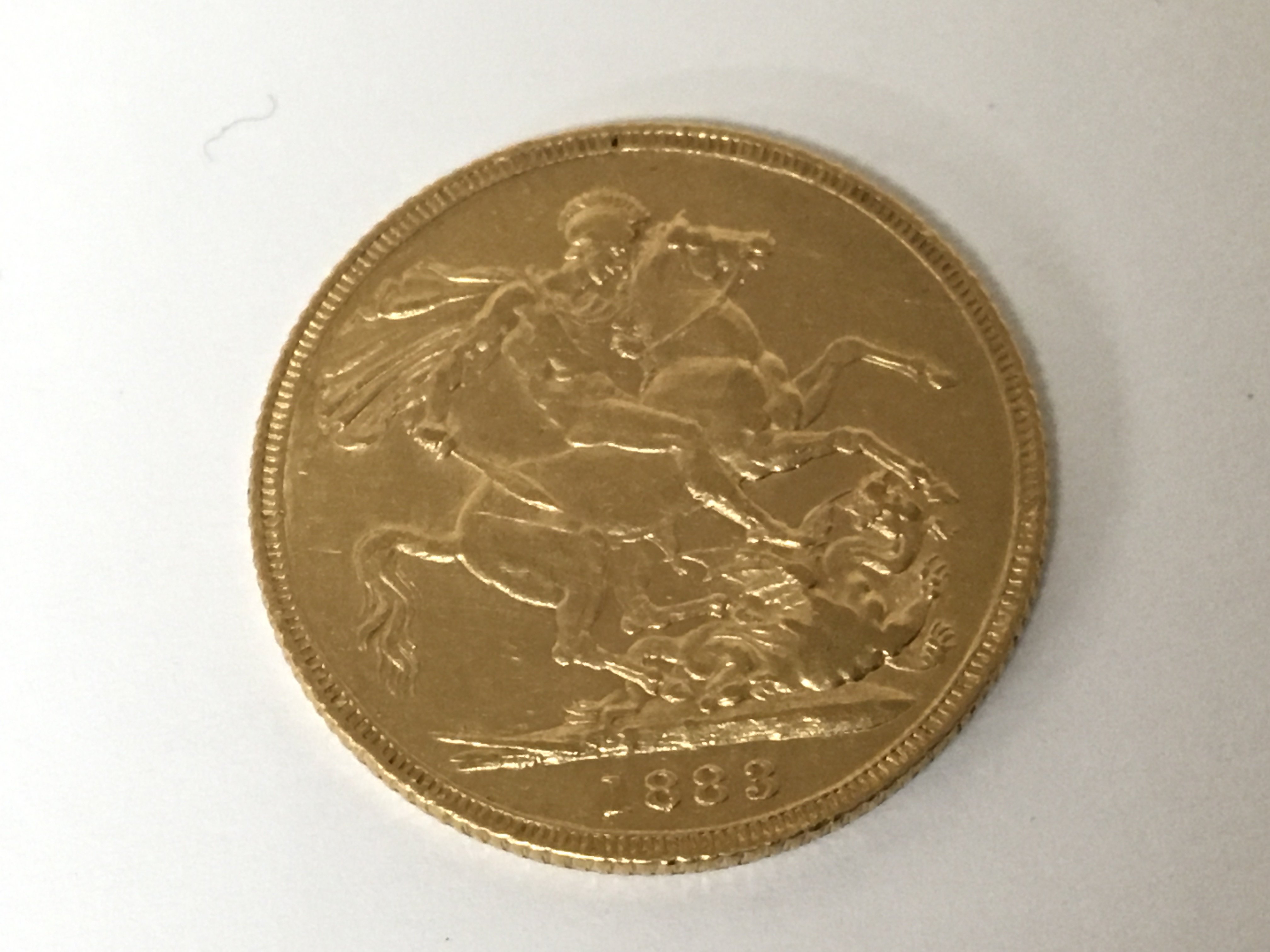 A Victorian gold sovereign dated 1883 with the young queens head side profile.