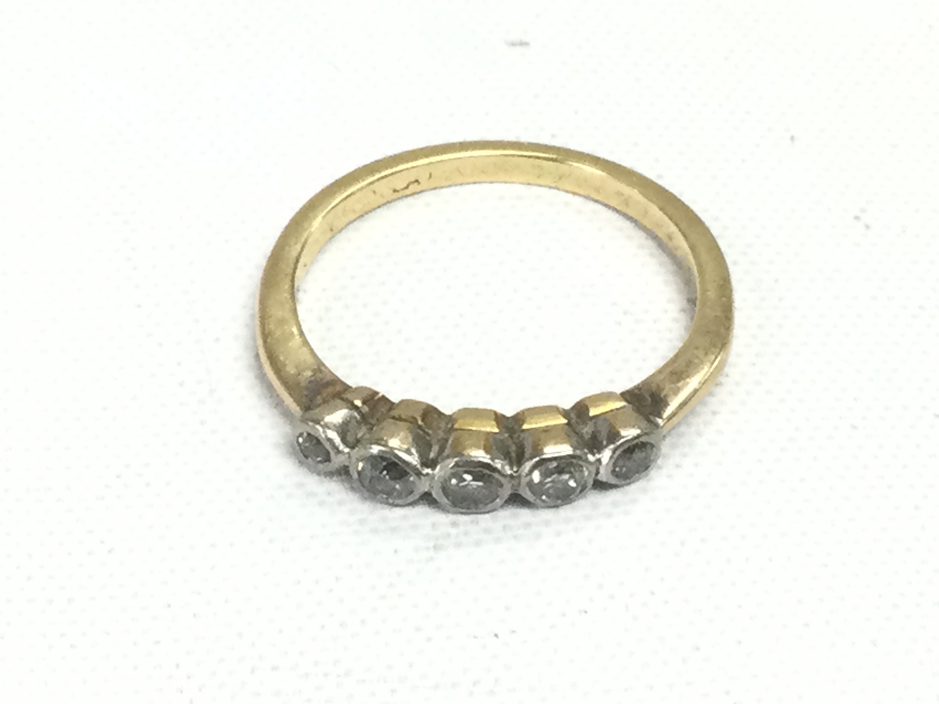 A gold five stone diamond ring, approx 2.5g and approx size K. Shipping category A.