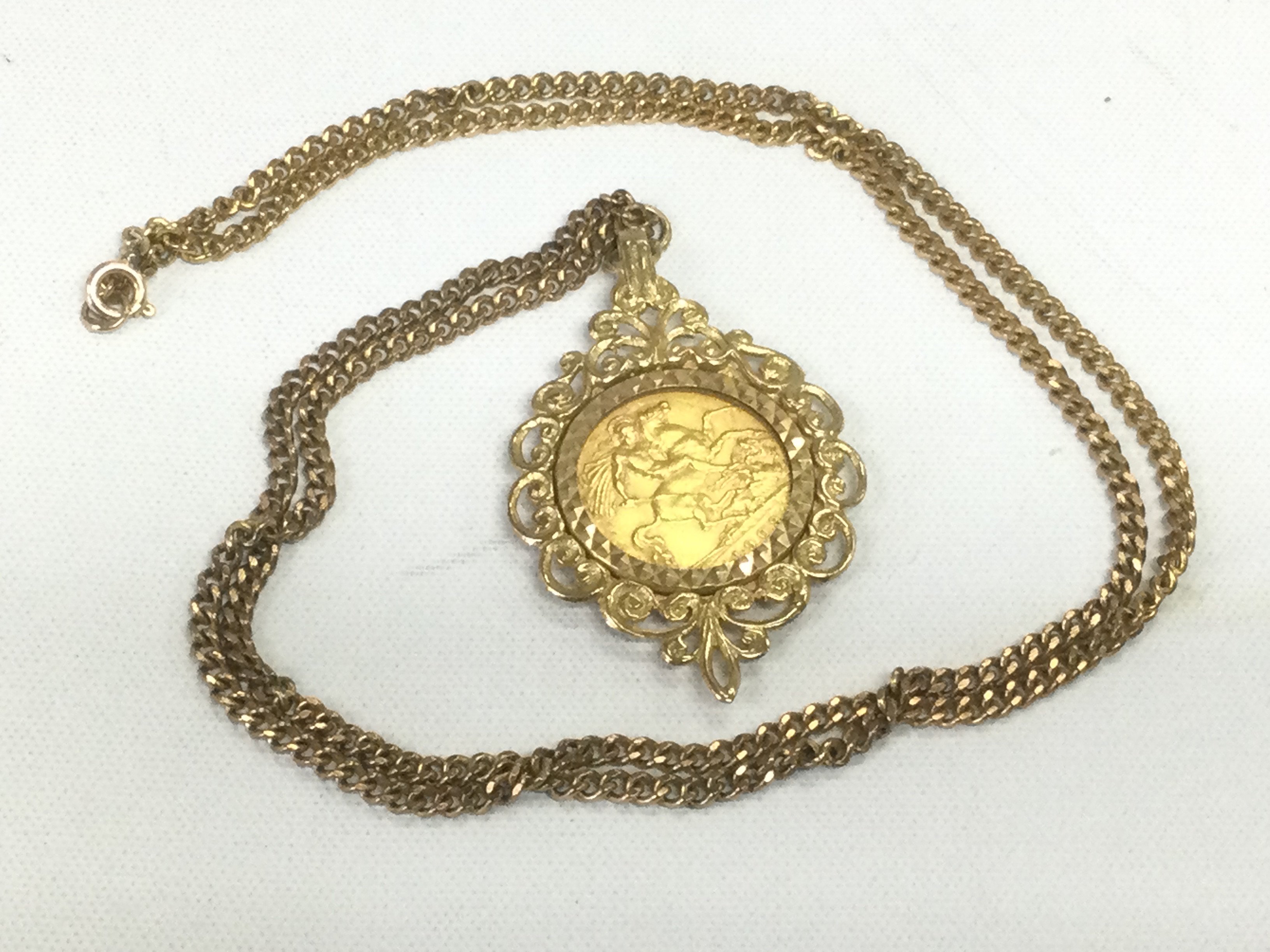 A 1909 gold sovereign on a gold chain, approx 17.7g. Shipping category A.
