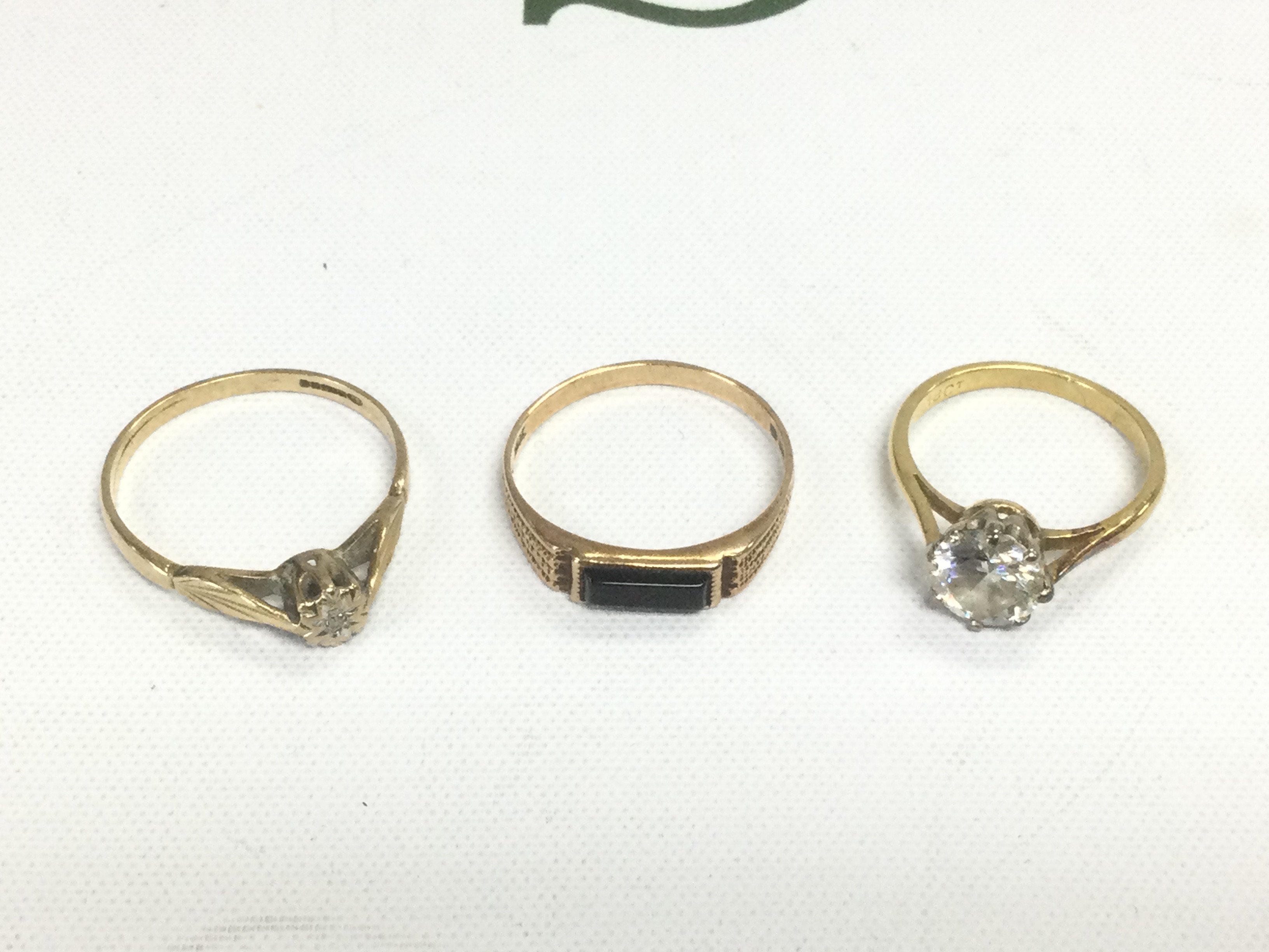 Three gold rings set with stones, approx total weight 5.4g. Shipping category A.
