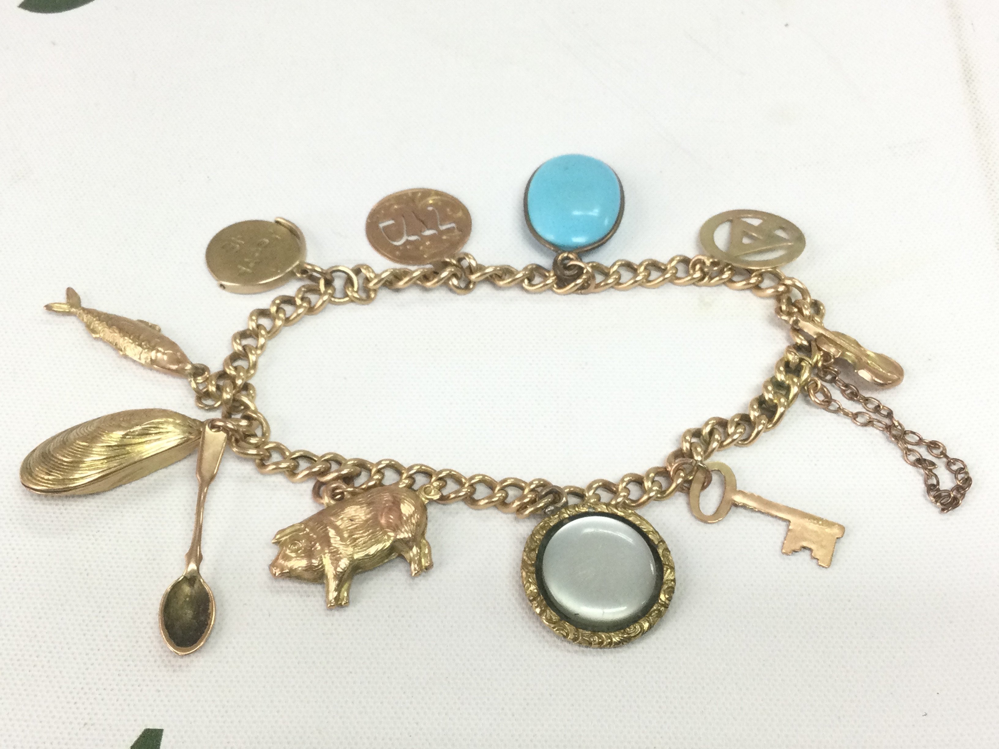 A 15ct gold charm bracelet, approx 16.7g. Shipping category A.