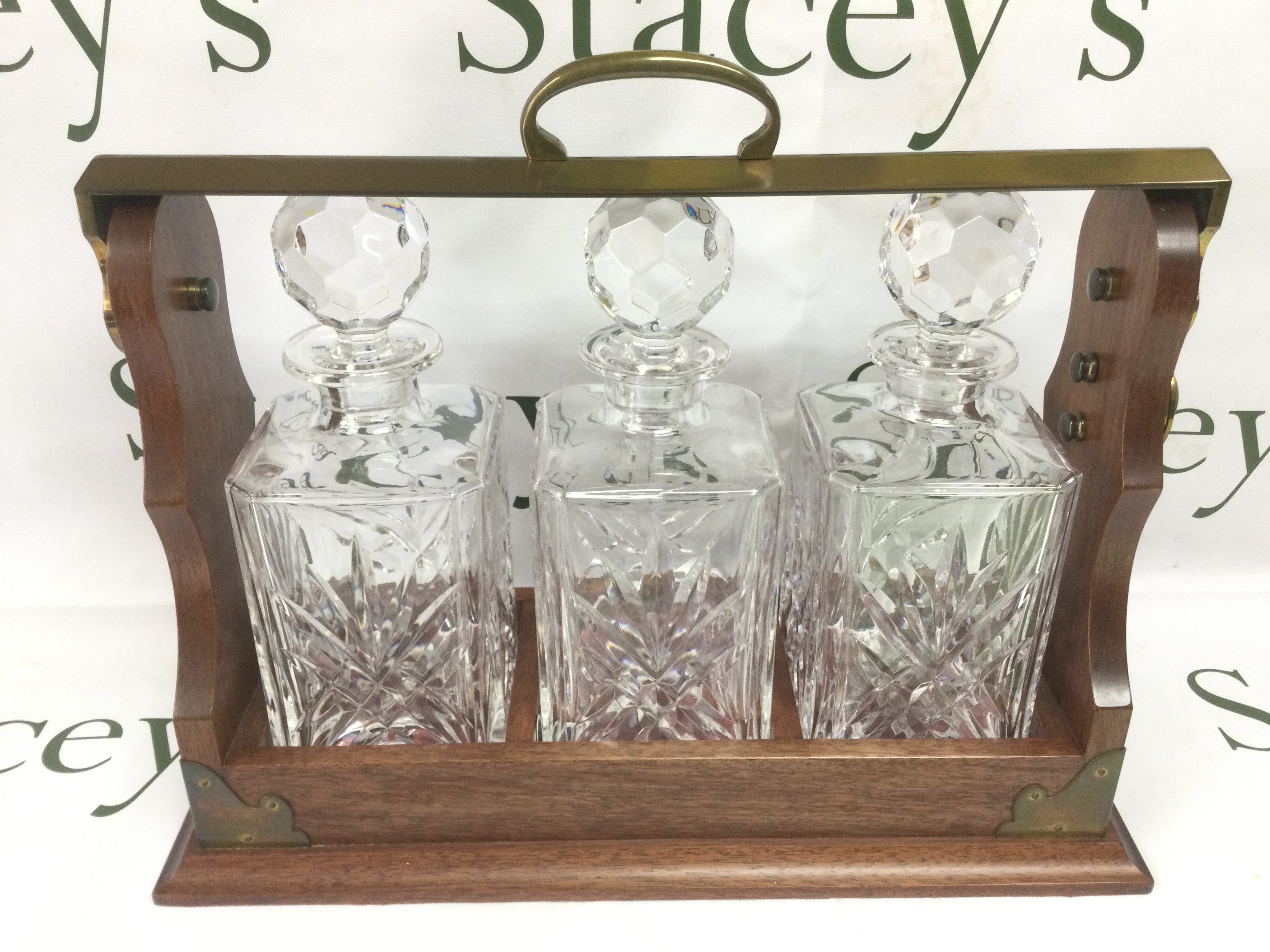 A reproduction three bottle tantalus. Shipping category D.