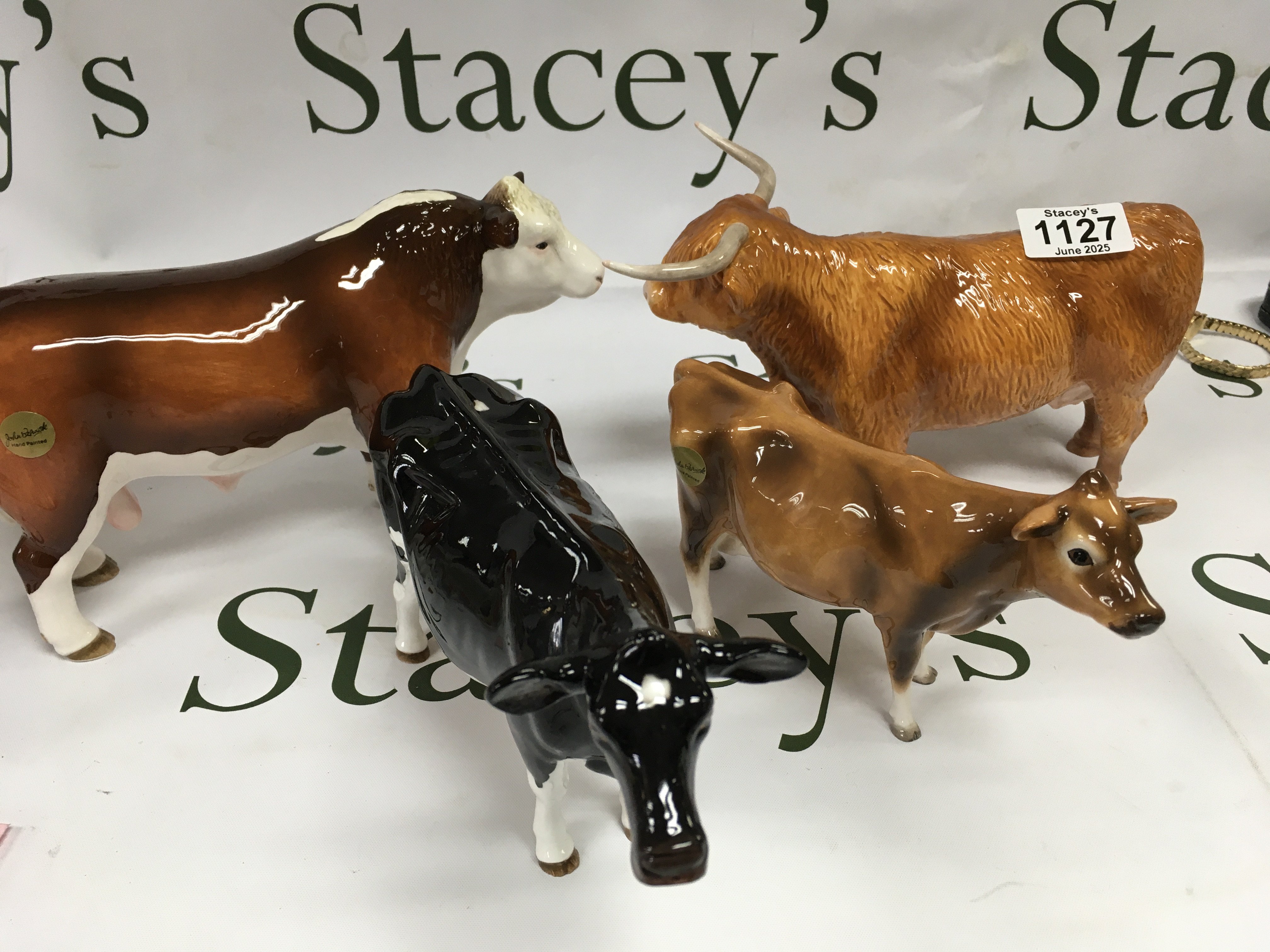 A collection of four Beswick cows including Highland Cattle.