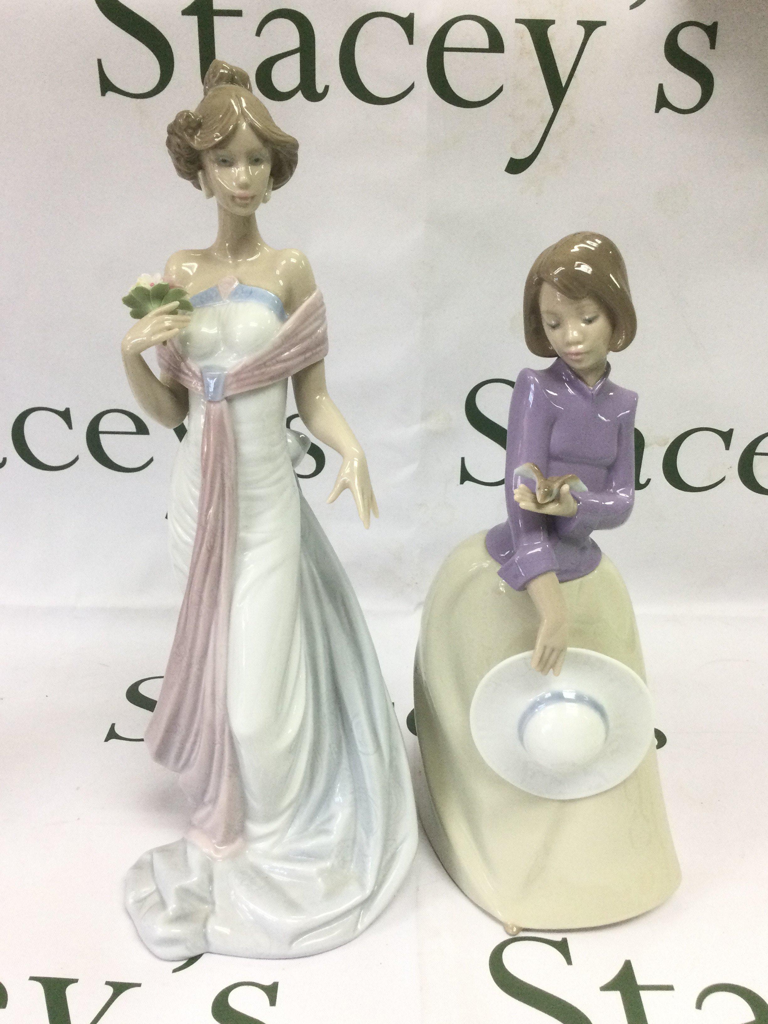 A Lladro and a Nao figure of ladies, tallest approx 32.5cm. Shipping category D.