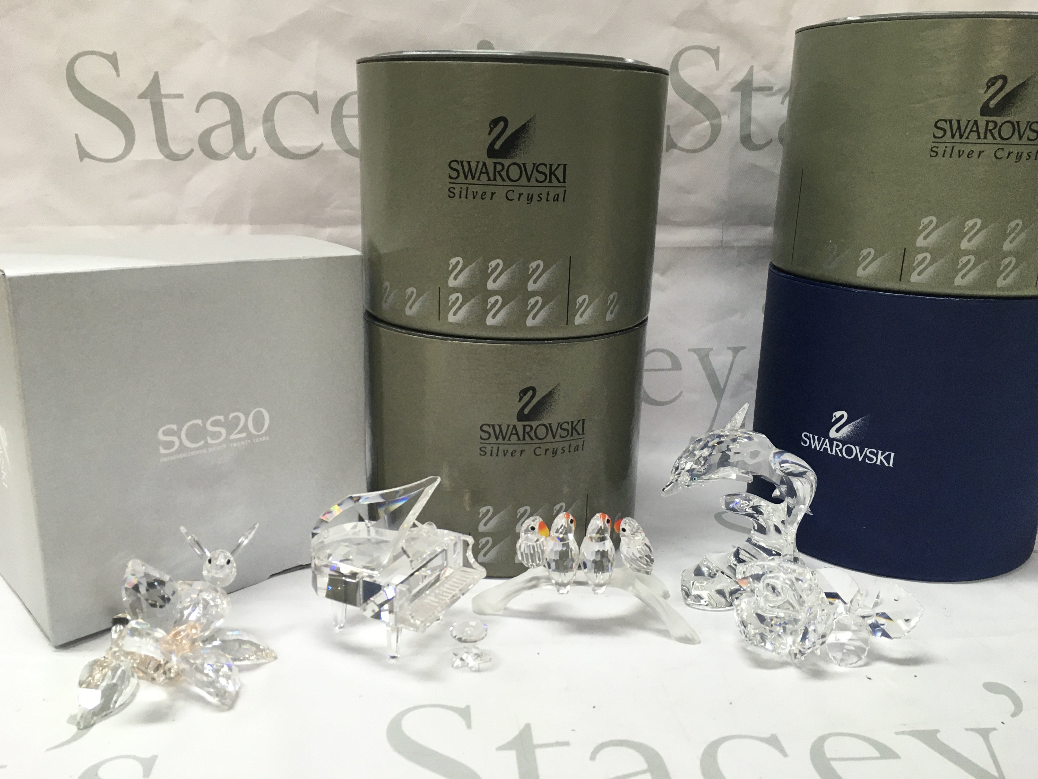 Boxed Swarovski figures including a Dolphin, rose, Bee, Lovebirds, Piano. Postage category C