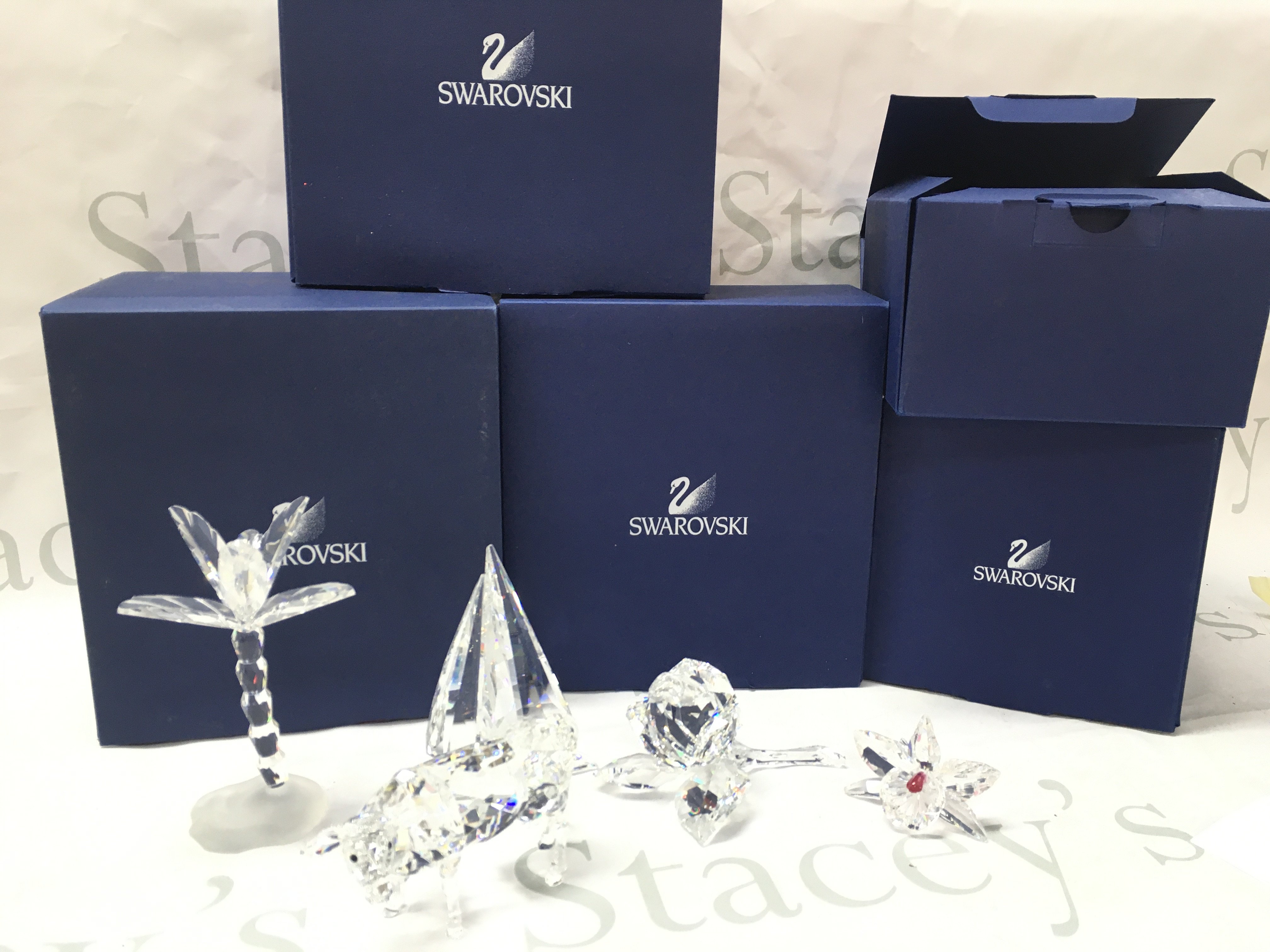 Boxed Swarovski crystal glass figures including a cow, palm tree, rose etc. postage catC