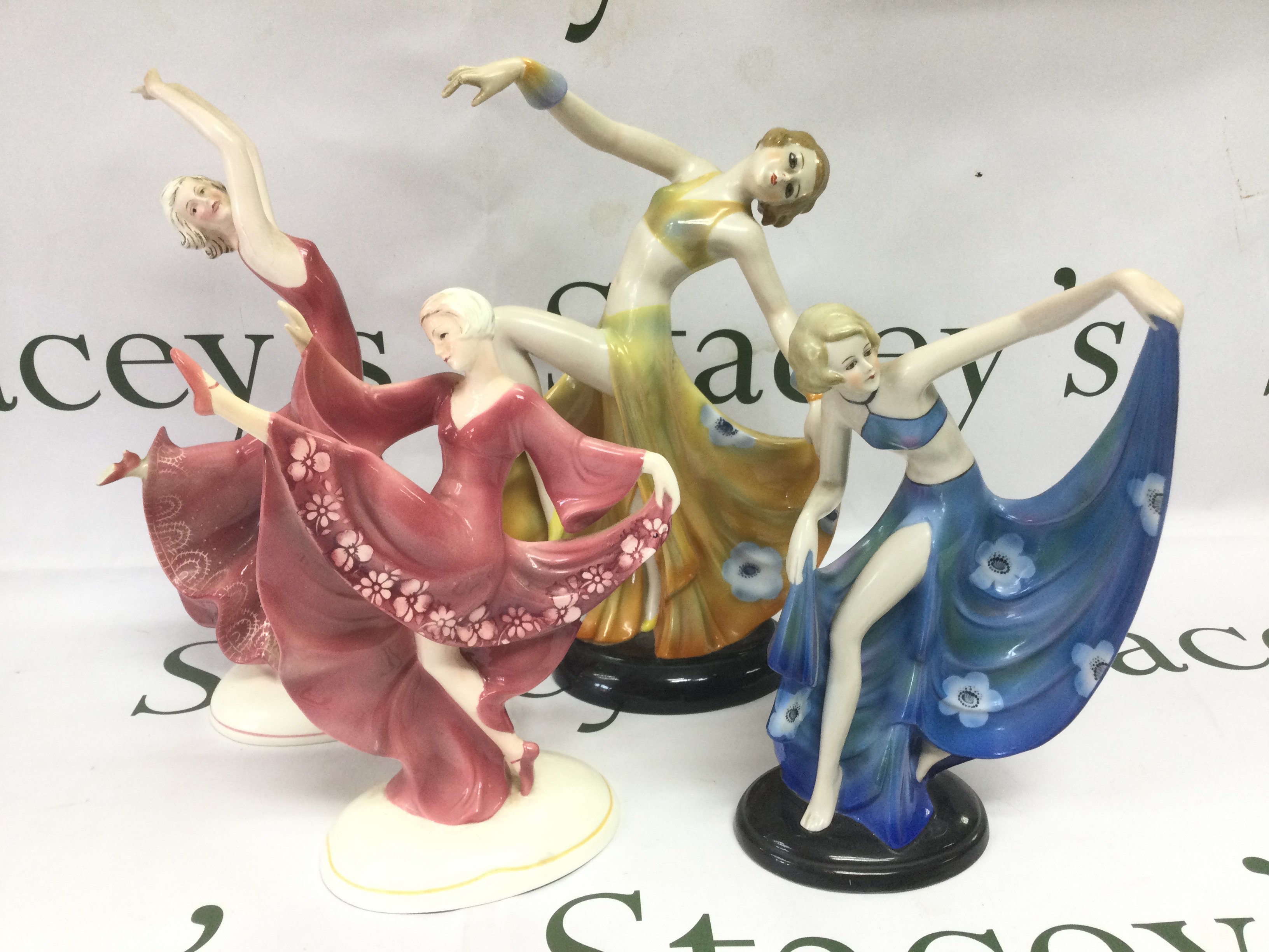 Four Art Deco figures of ladies, tallest approx 27cm. Shipping category D.