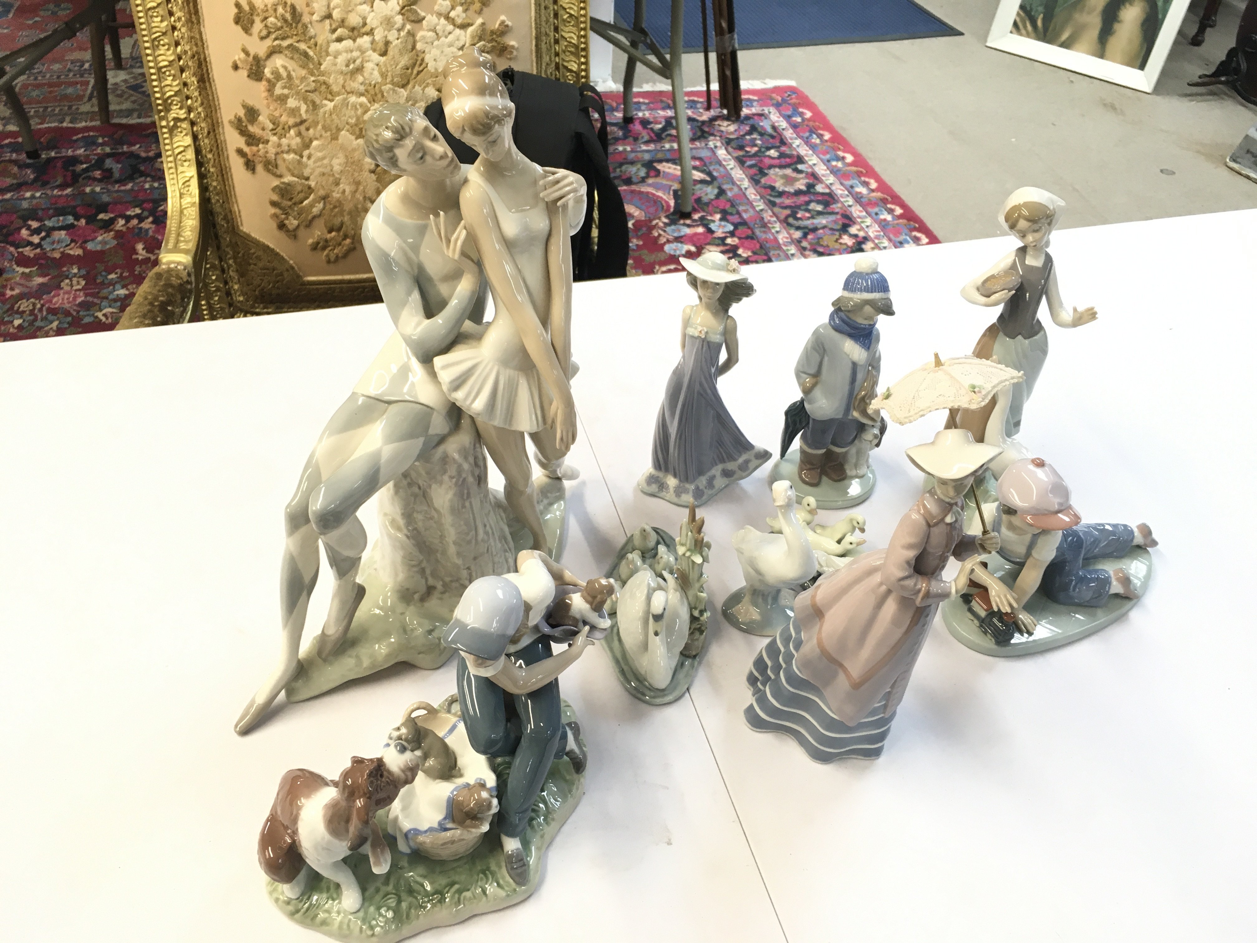 A collection of Lladro porcelain figures including Harlequin and ballerina, Susan, Parisian lady etc. this lot cannot be posted