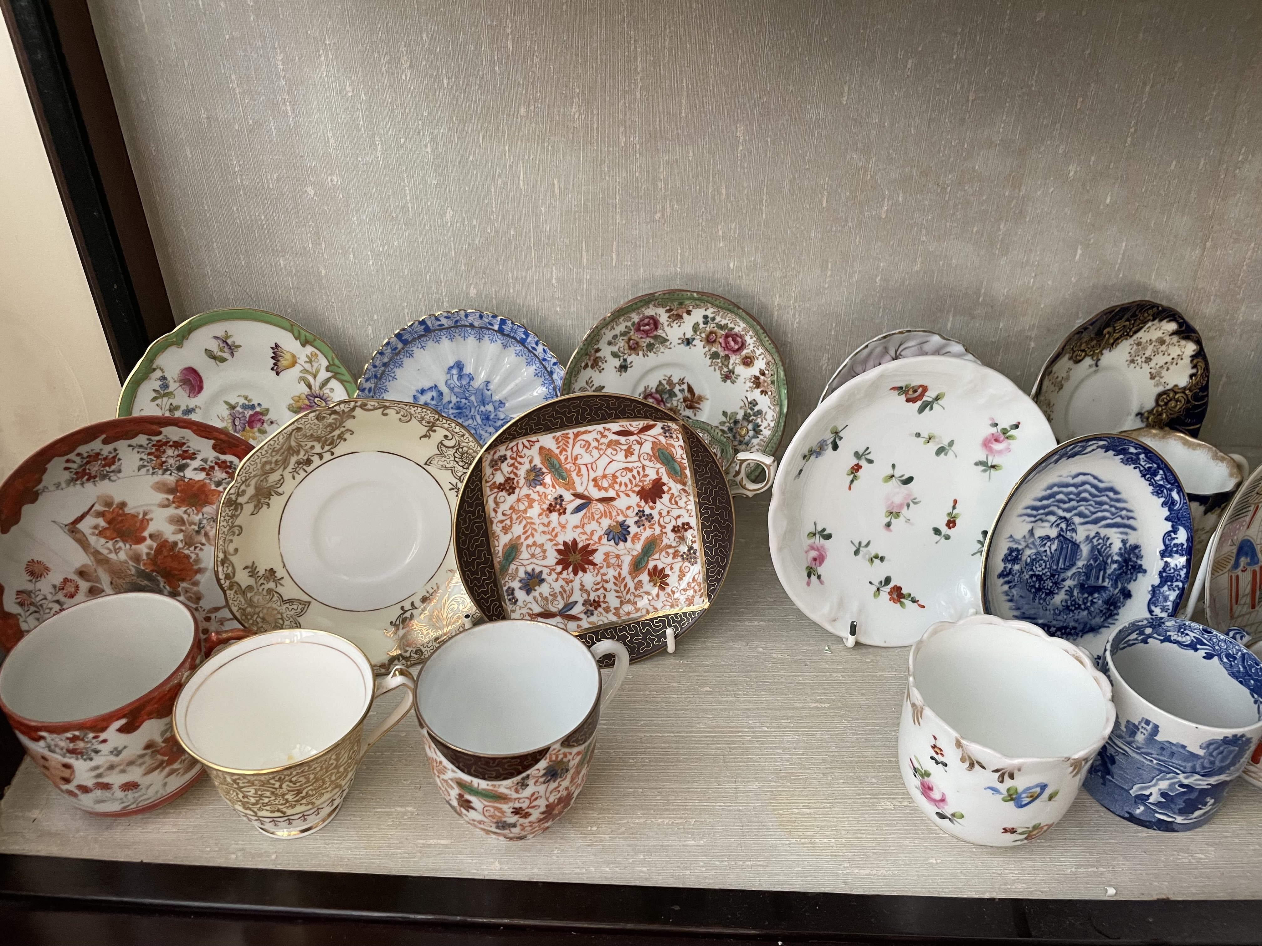 A collection of various teacups and saucers. Shipping category D.