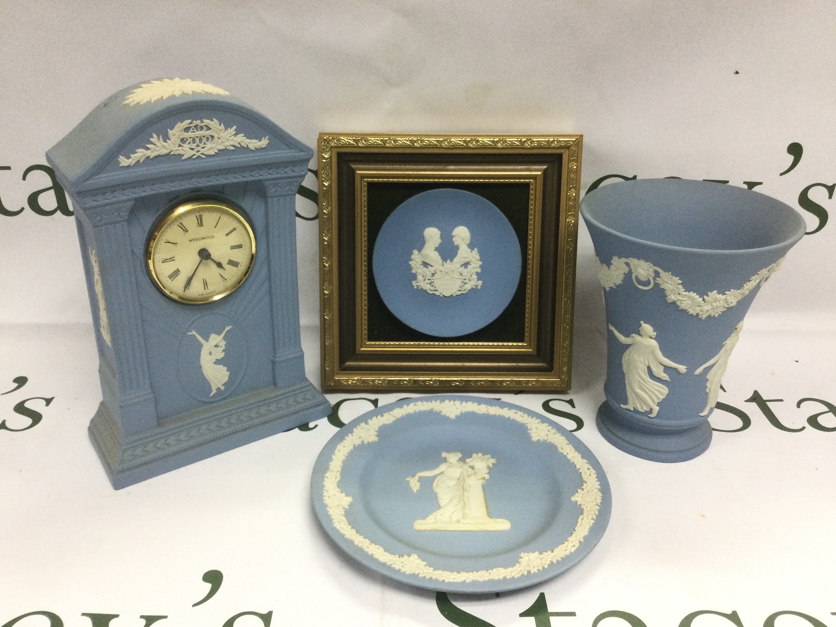 Four Wedgwood jasperware items comprising a mantle clock, vase, dish and a wall mounted commemorative dish (4).