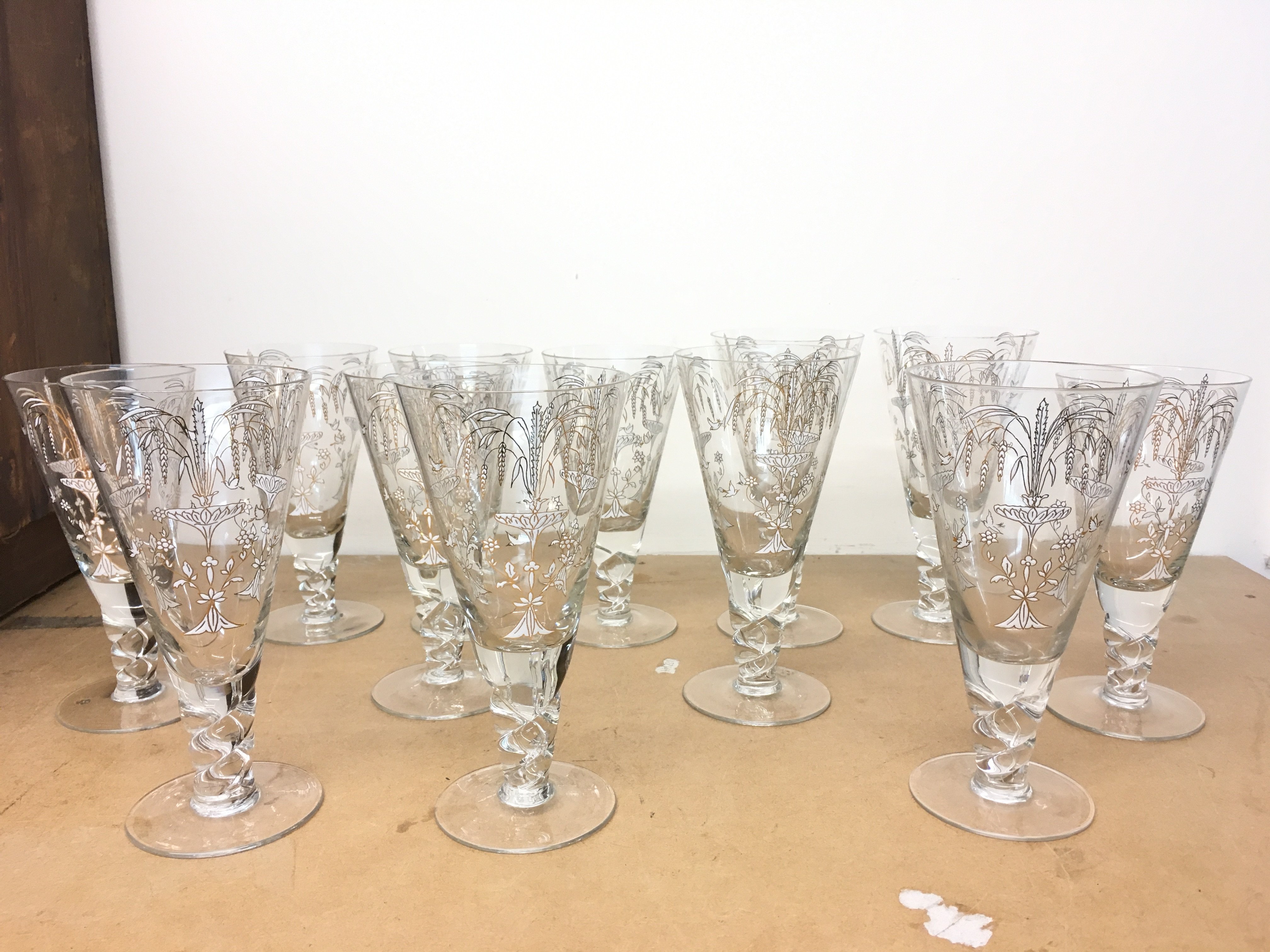 12 drinking glasses with gilt decoration . This lot cannot be posted