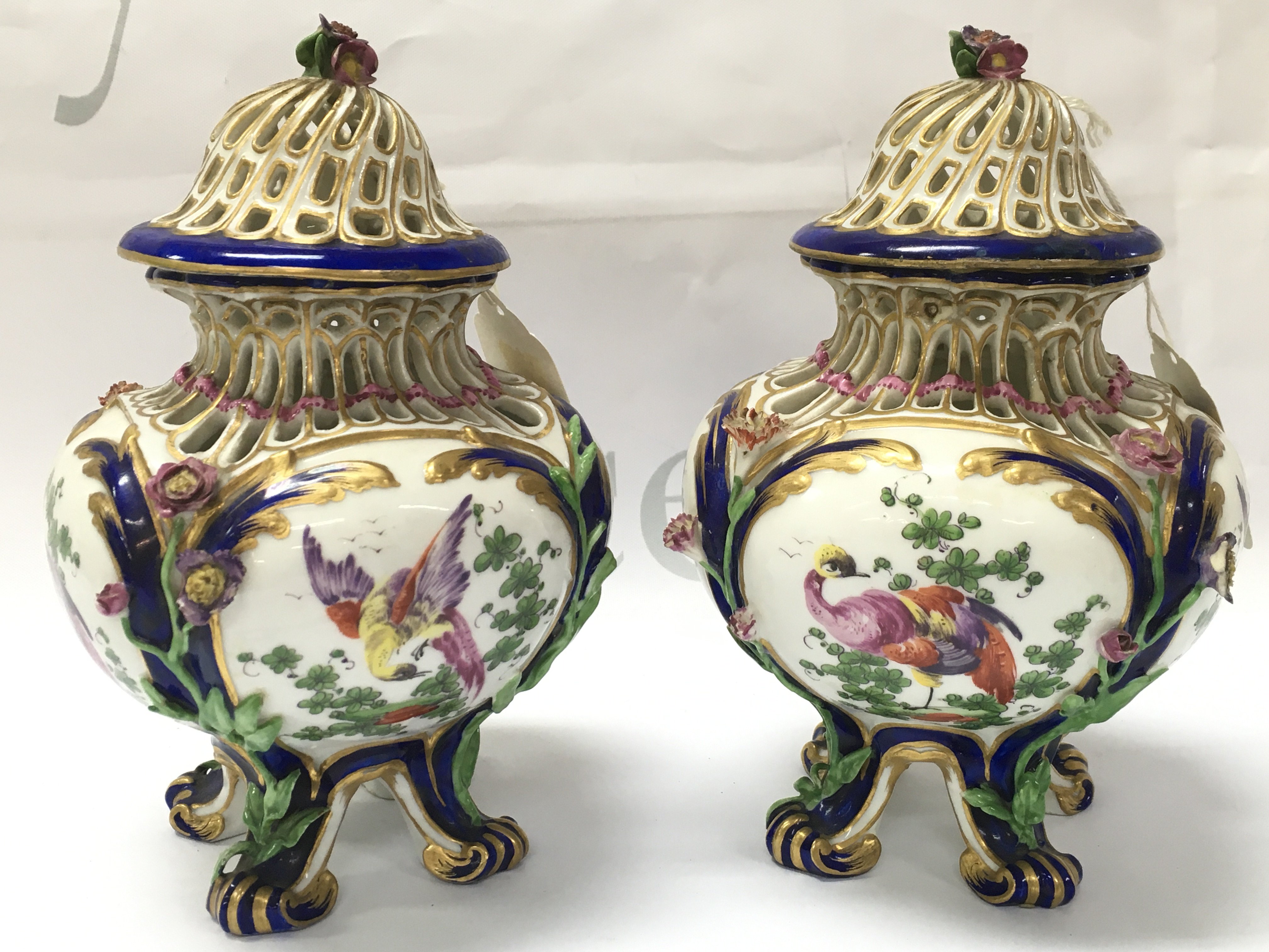 A pair of small 19th century pot porri vases in the style of Vincennes with hand painted mythical bird decoration. Some restoration. Marked H at base. This lot cannot be posted