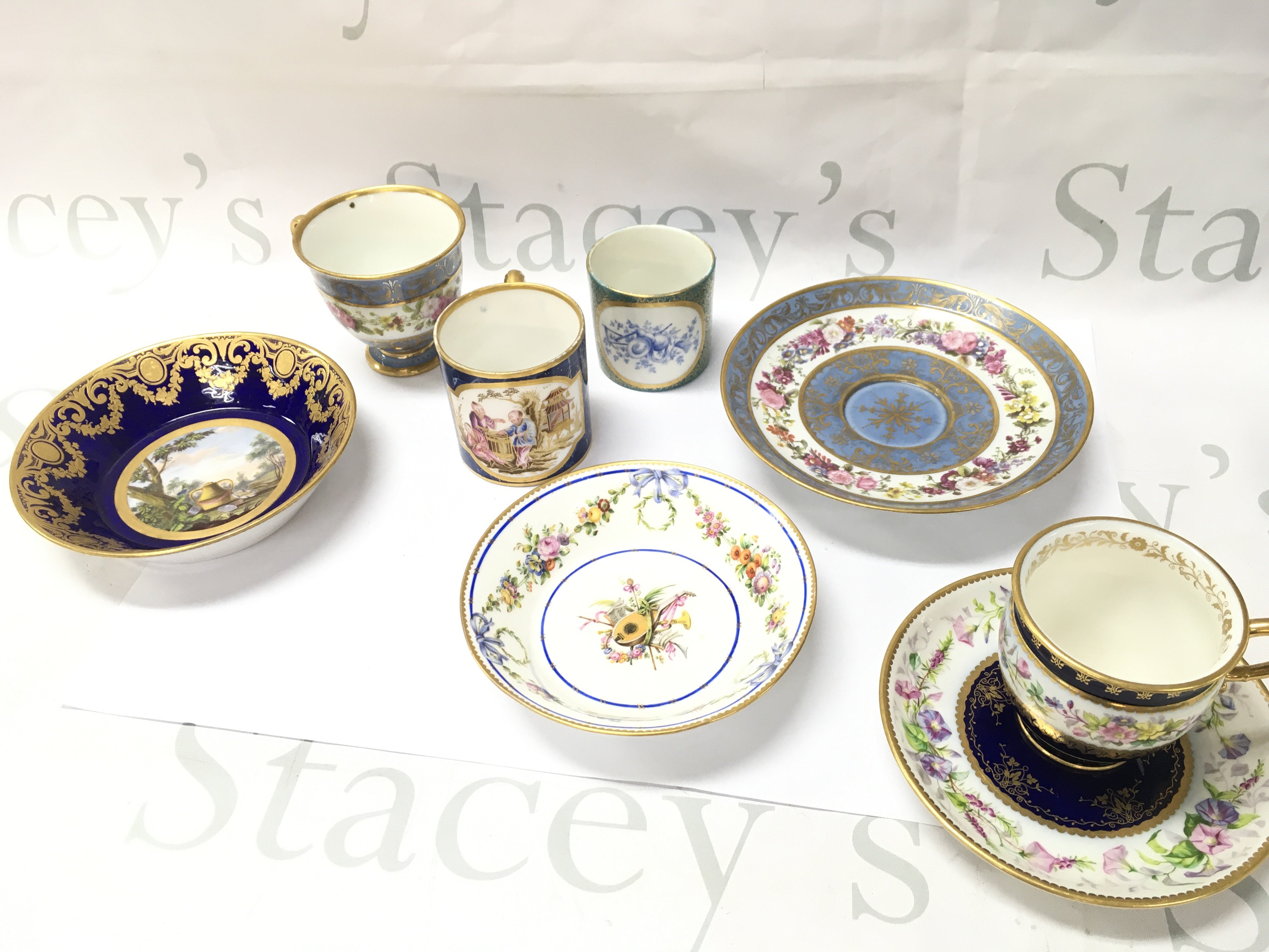 A collection of Sevres ceramics including dishes and cups , one dish dated 1779 decorated with an urn in a country scene painters mark for Jean Chabry & gilders mark for Michelle Barnabie Chauvaux . Some restoration. This lot cannot be posted