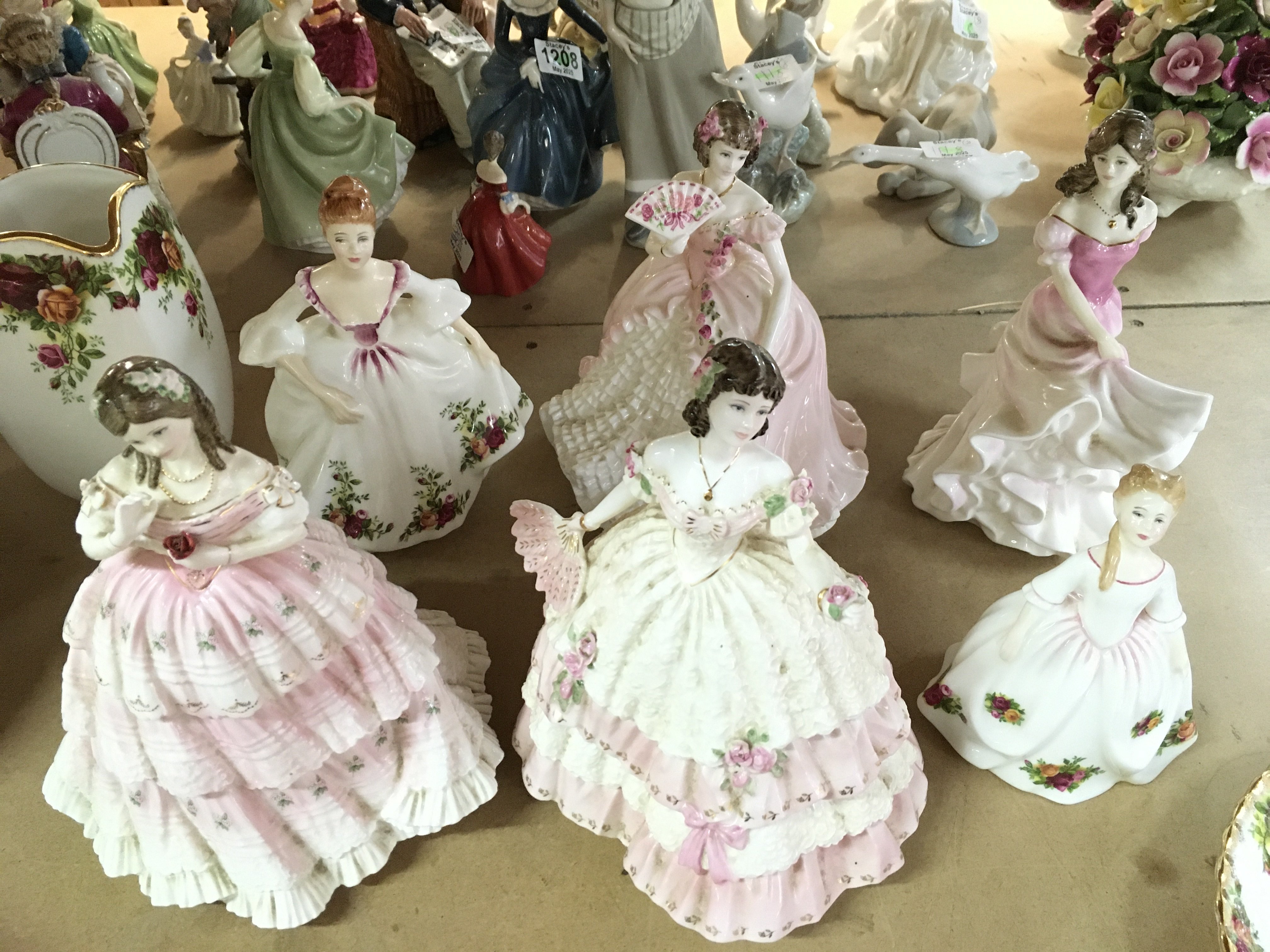 A collection of porcelain figures including Royal Doulton and Coalport. This lot cannot be posted