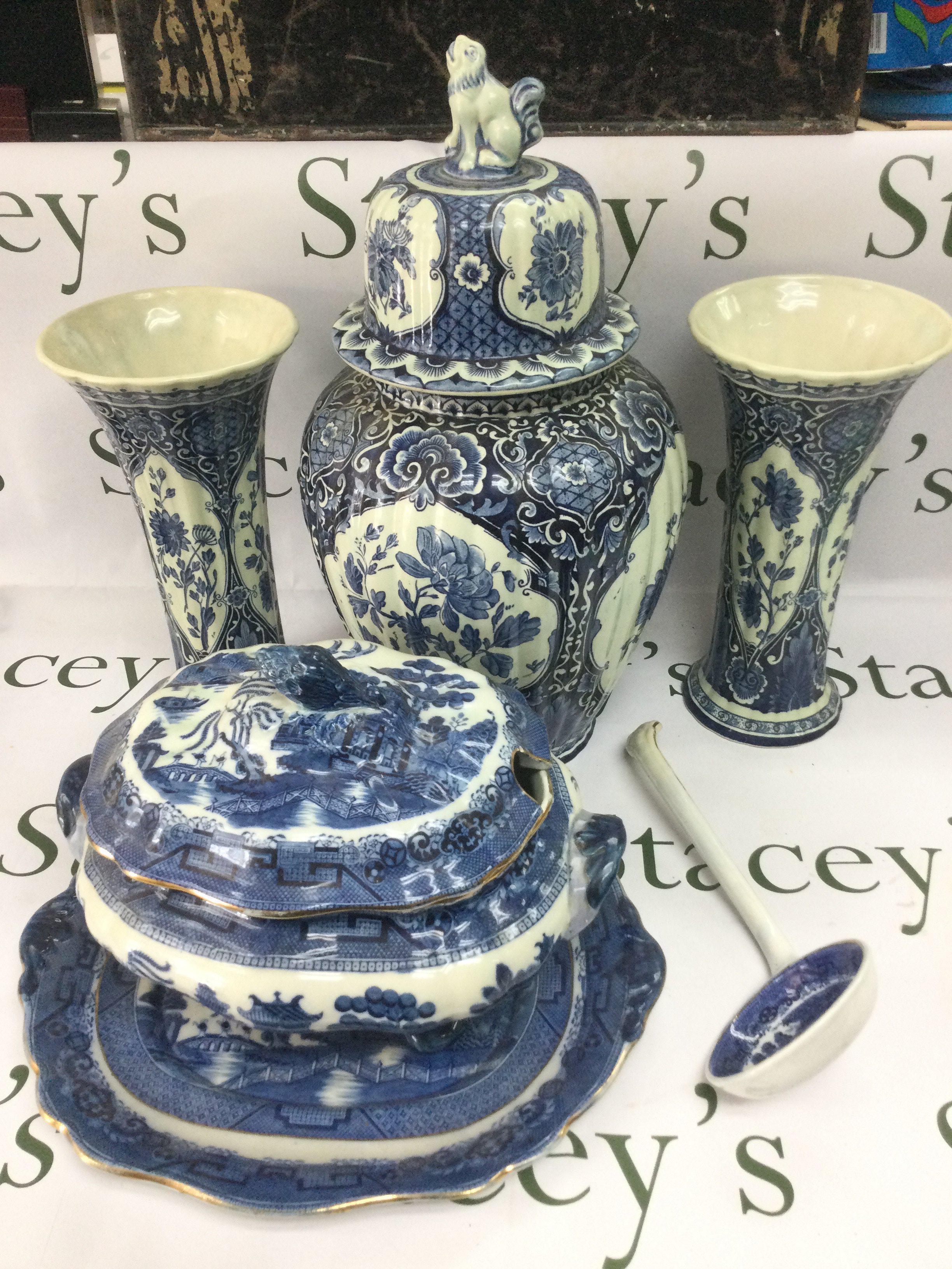 A small collection of blue snd white ceramics including a Delft garniture, approx height 46cm, a tureen and cover with ladle and a pair of modern porcelain vases. Shipping category D.