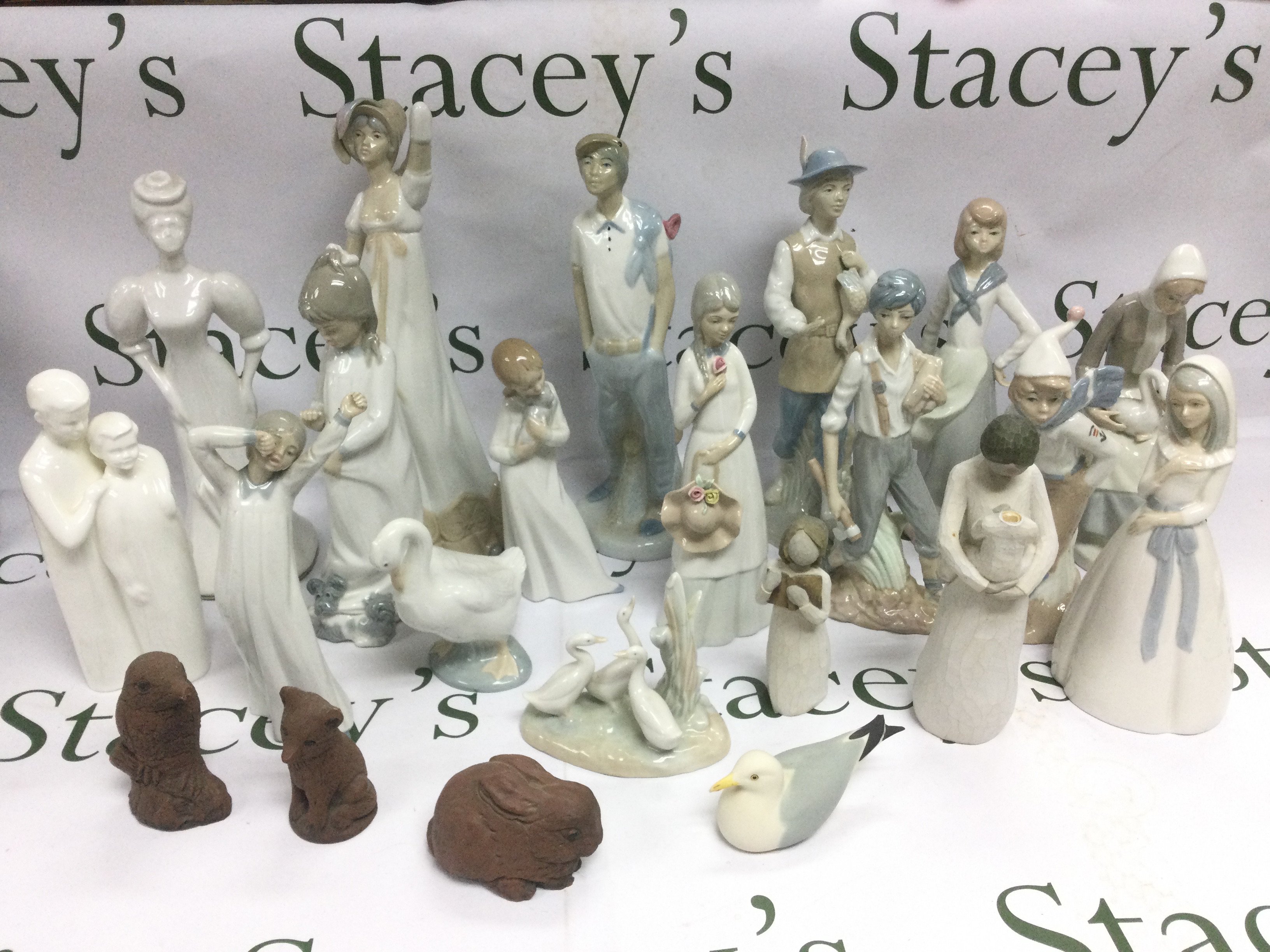 A collection of ceramics comprising mainly Lladro style figures including Nao examples plus Royal Doulton etc. Shipping category D.