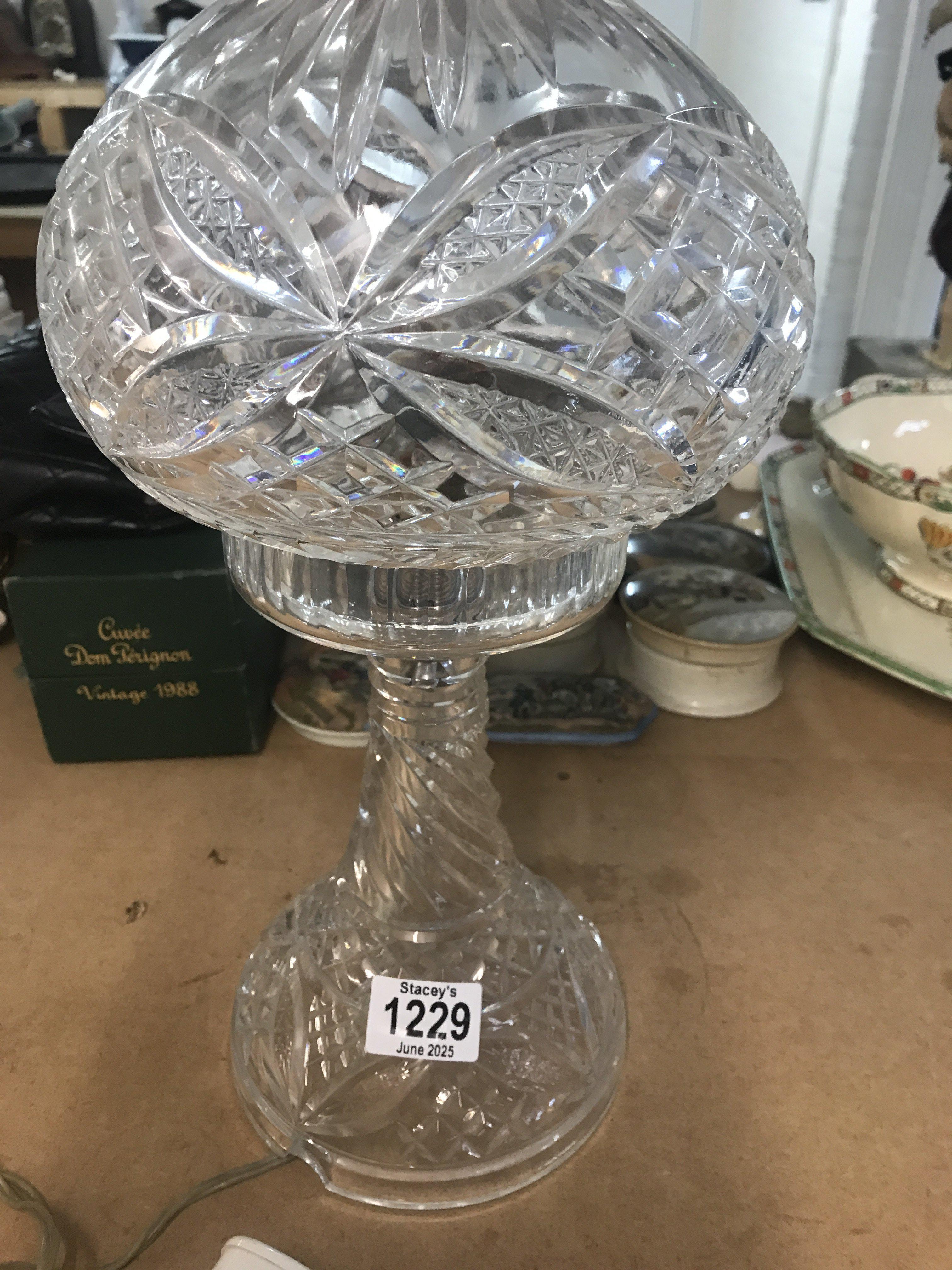 A cut glass side lamp .