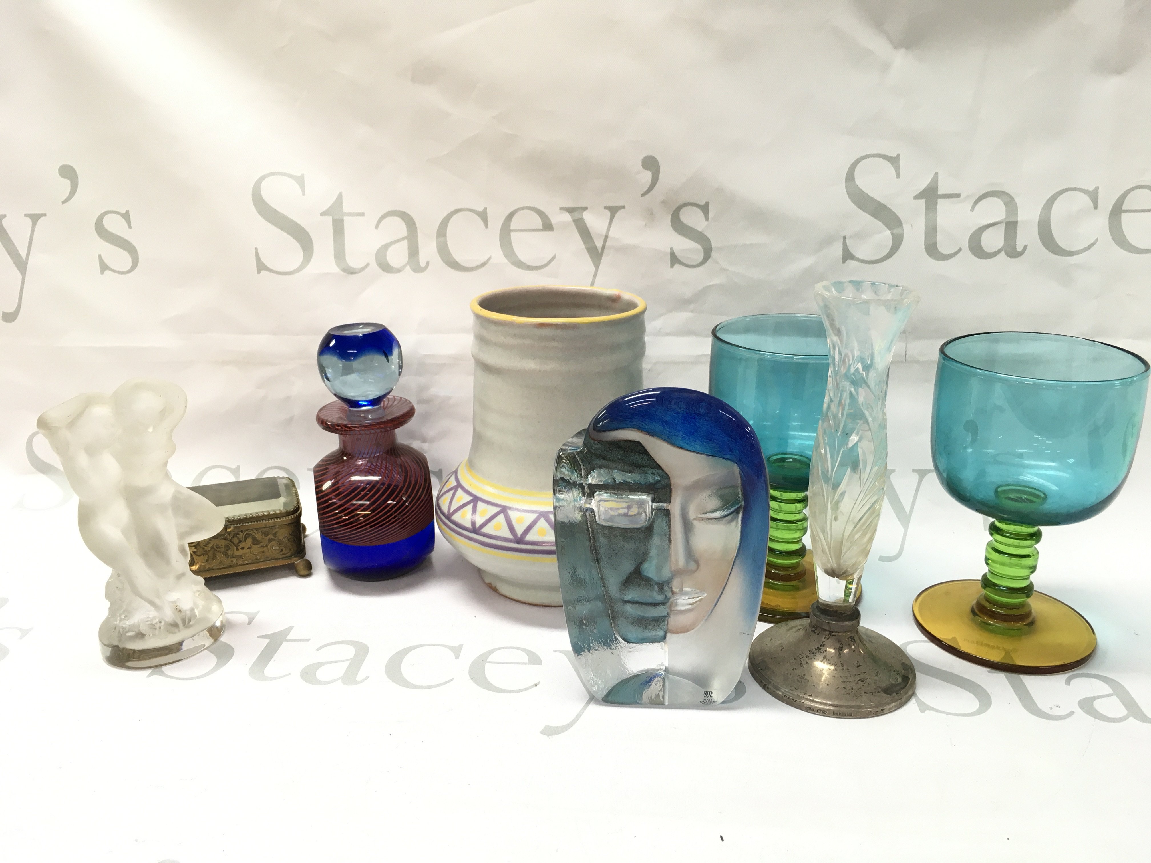 A collection of art glass ceramics including a French mid 20th century design Lalique woman figure group, Mats Jonasson paperweight, Merimakko glasses, Poole vase , silver hallmarked base glass vase