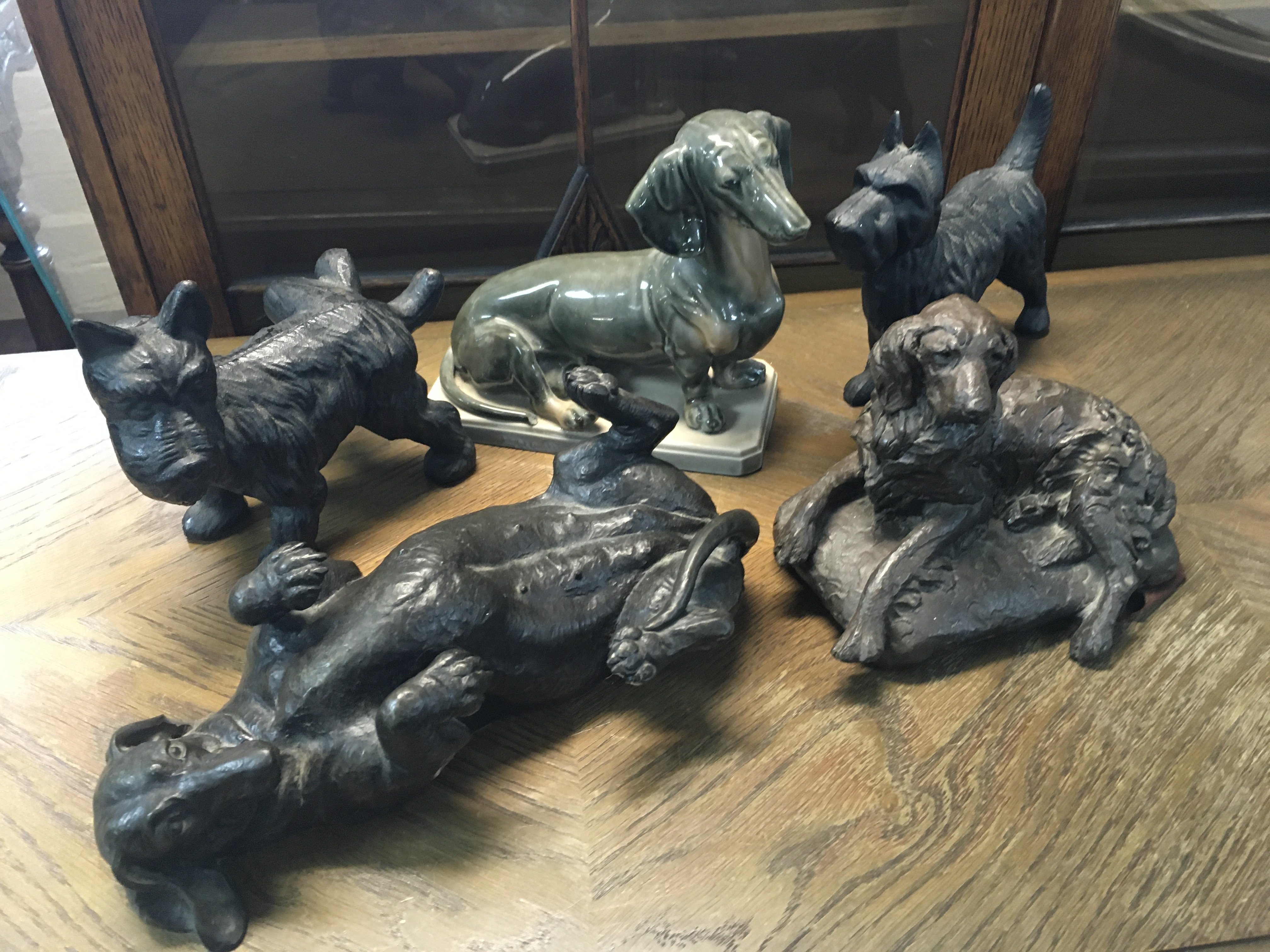 A collection of dog figures including a ceramic Dash Hound, simulated bronze Dash Hound etc. this lot cannot be posted