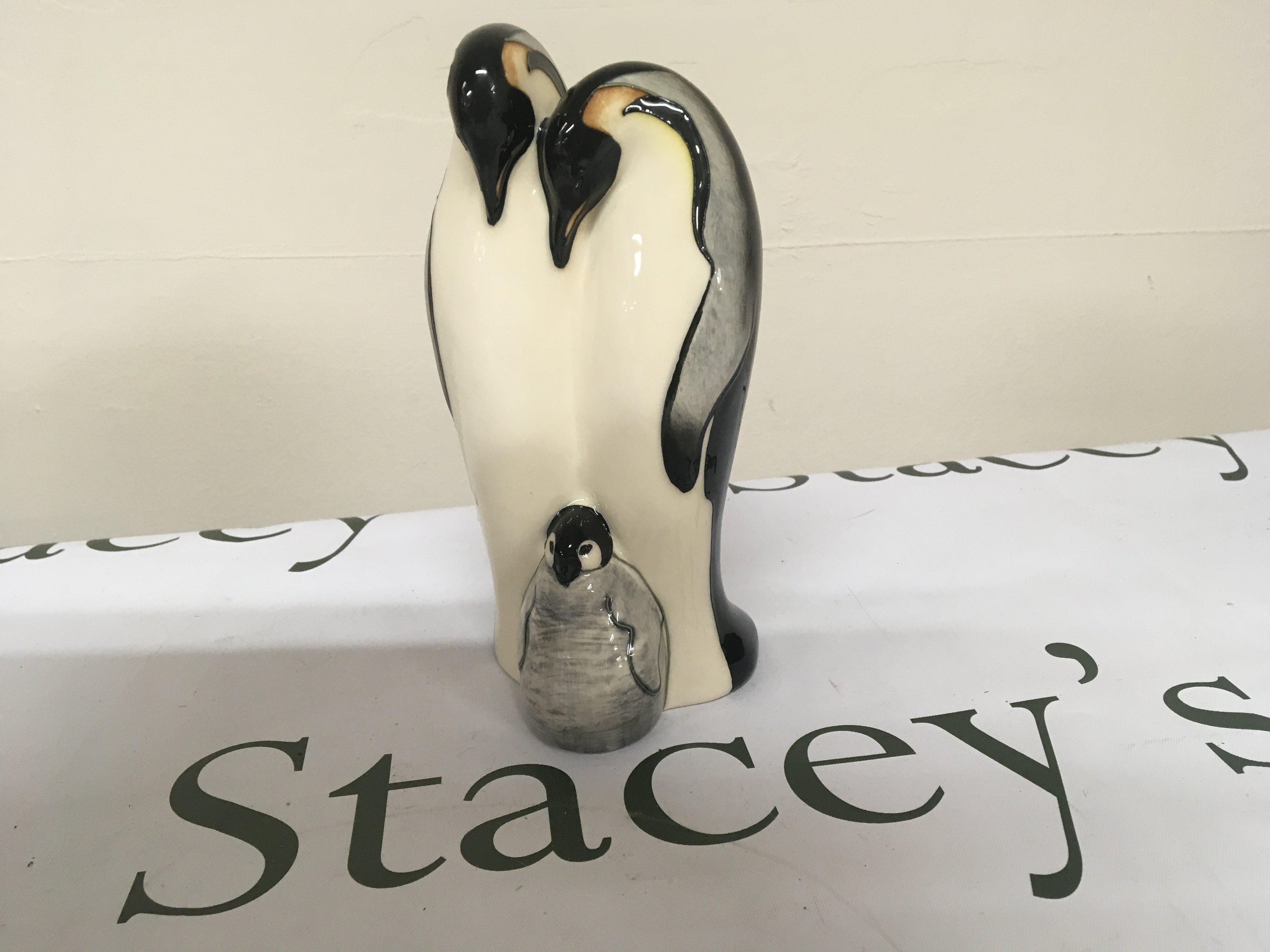 A Moorcroft ceramic ornament in the form of Penguins. dated 2009. Height 18cm no obvious damage.