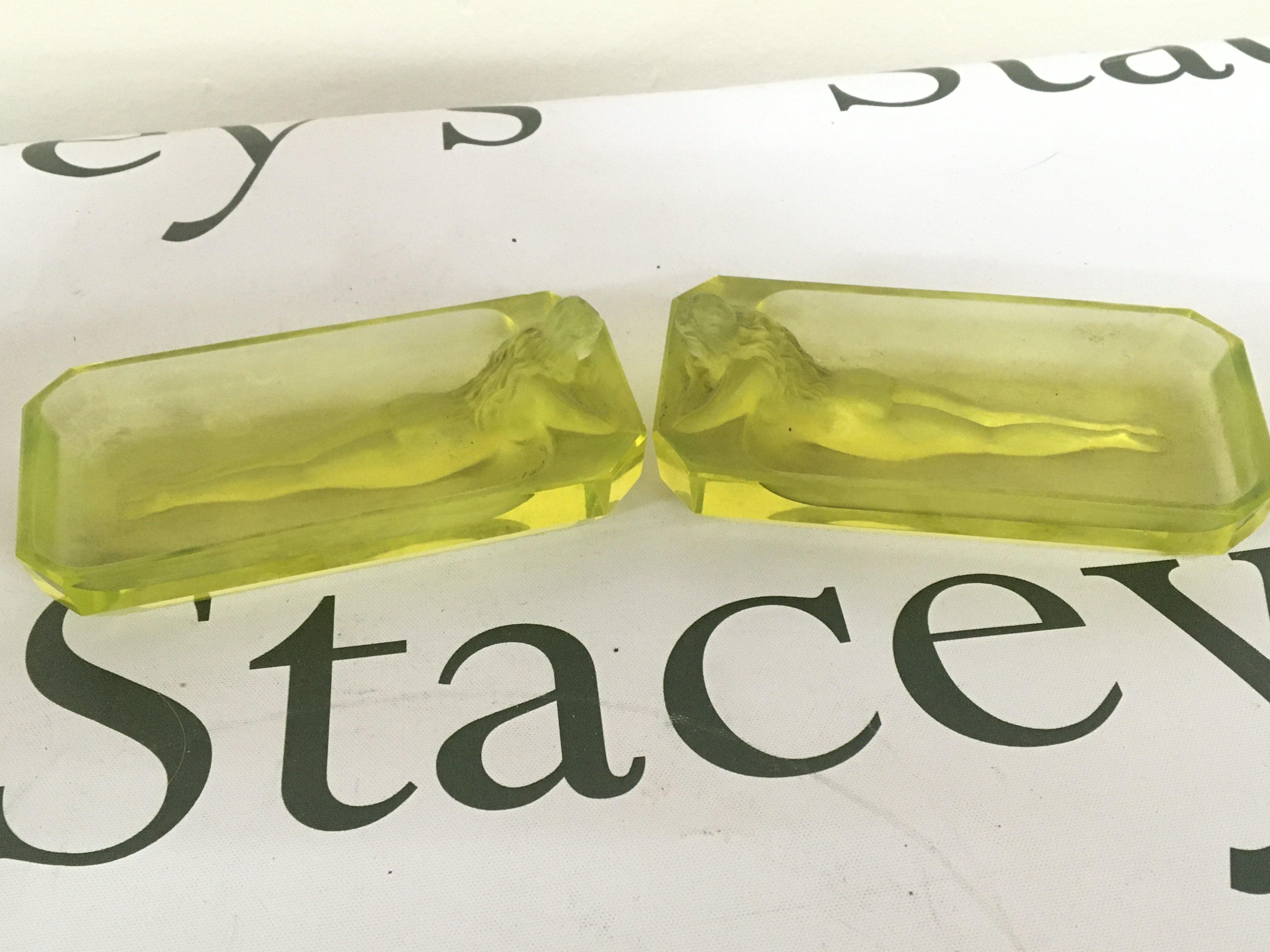 A pair of Uranium Art Deco glass dishes of rectangular shape moulded with a raised nude figure. Length 11.5cm