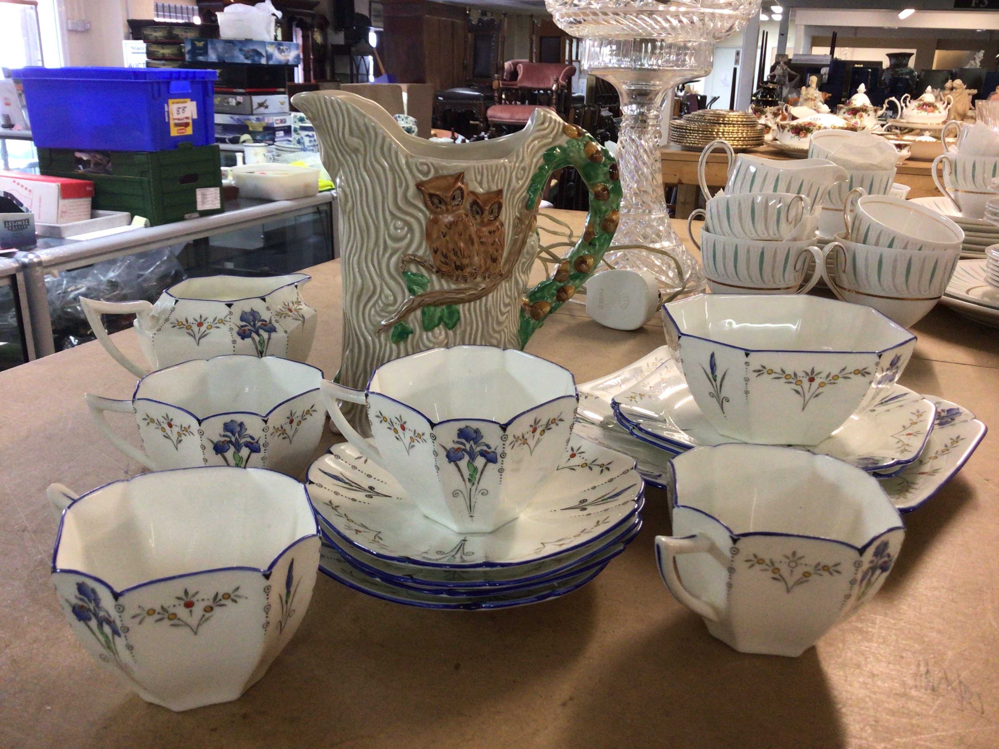 A part Shelley tea set together with a Clarice Cliff Newport Pottery jug in the form of a tree trunk decorated with owls, foliage and acorns