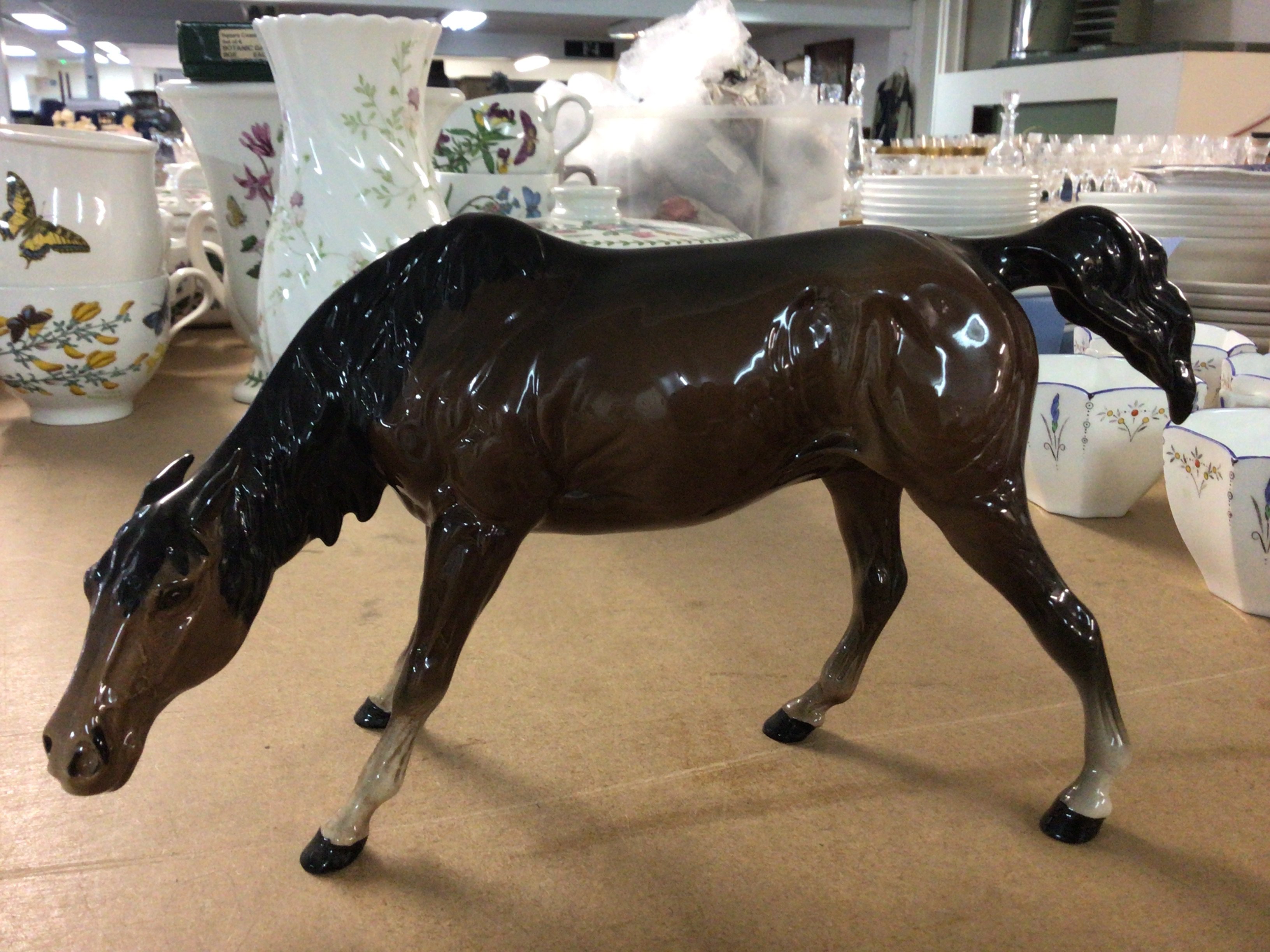 A Royal Doulton horse with its head down