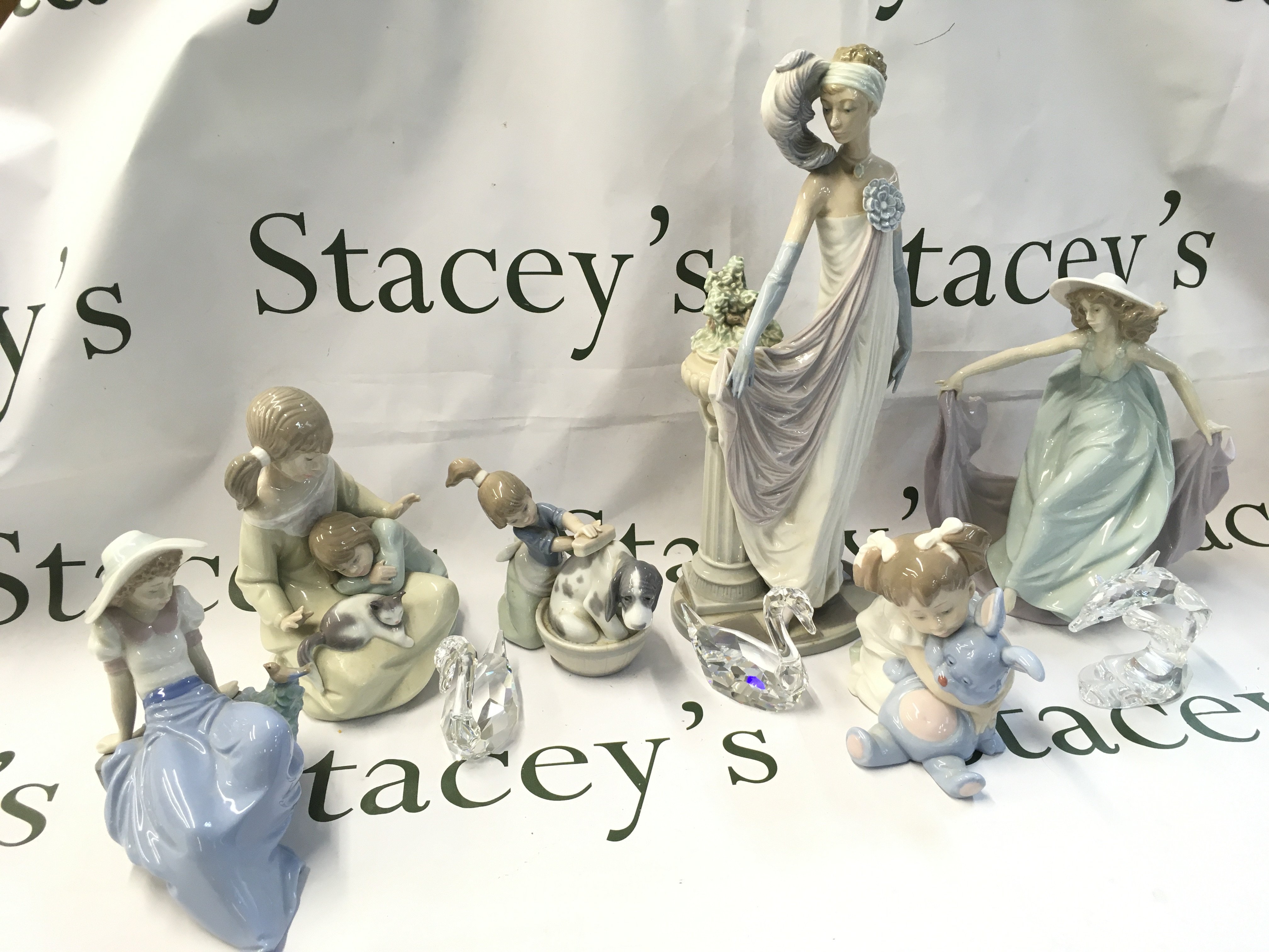 Lladro, Nao and Swarovski porcelain and crystal glass figures . This lot cannot be posted