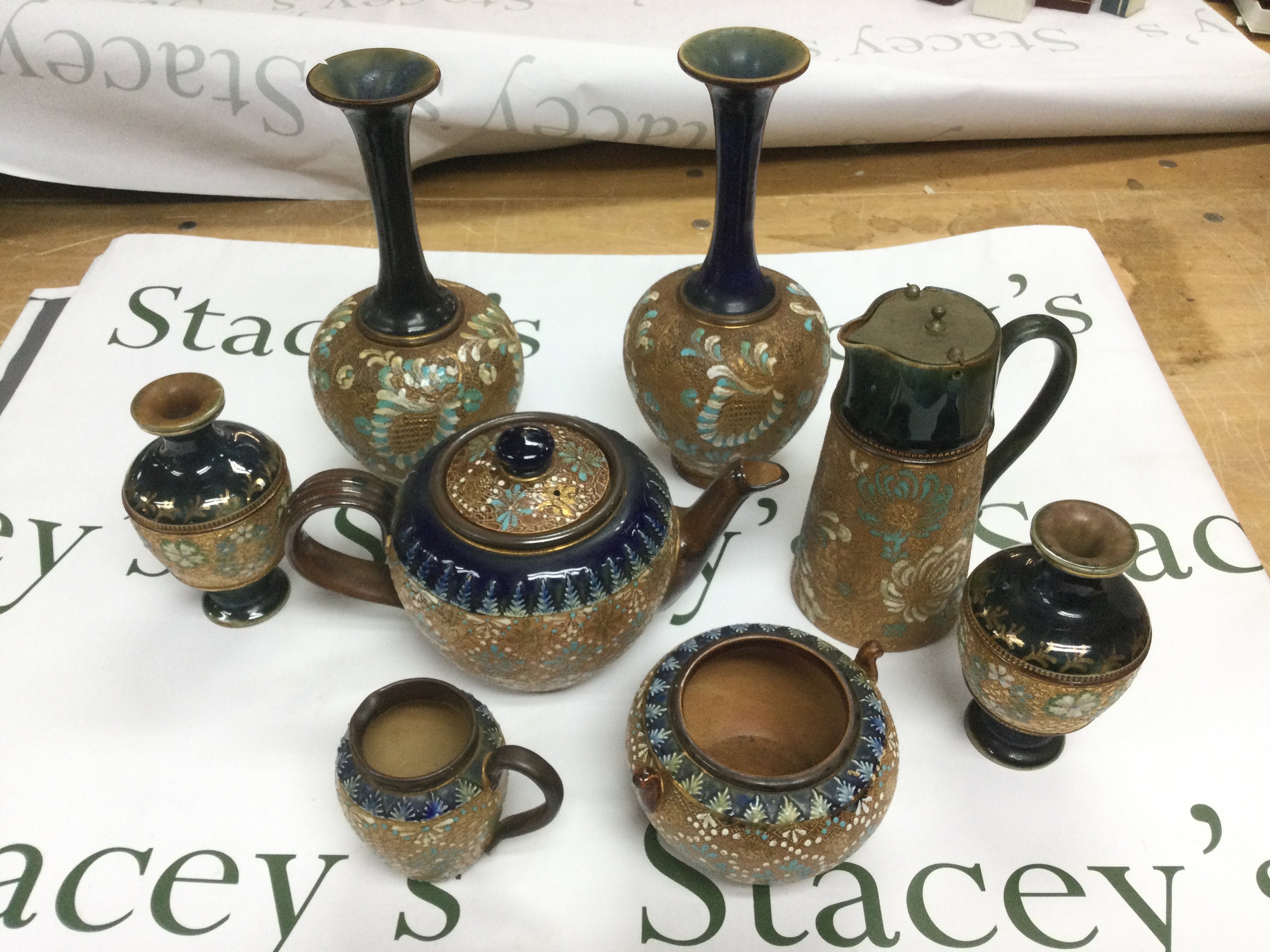 A collection of Doulton Lambeth items comprising a teapot, vases etc. Shipping category D.