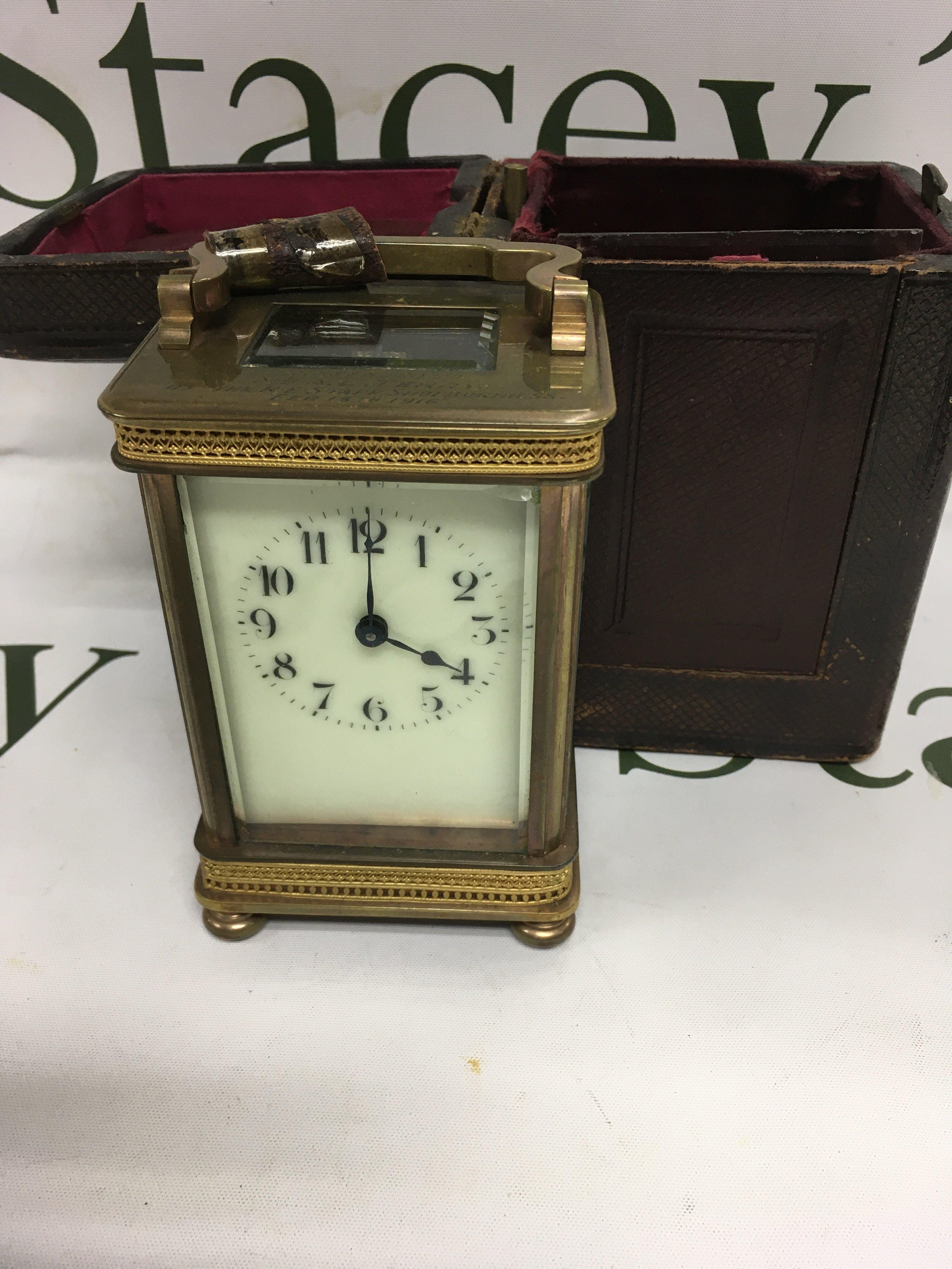 A brass carriage clock the dial with Arabic numerals fitted in original case .