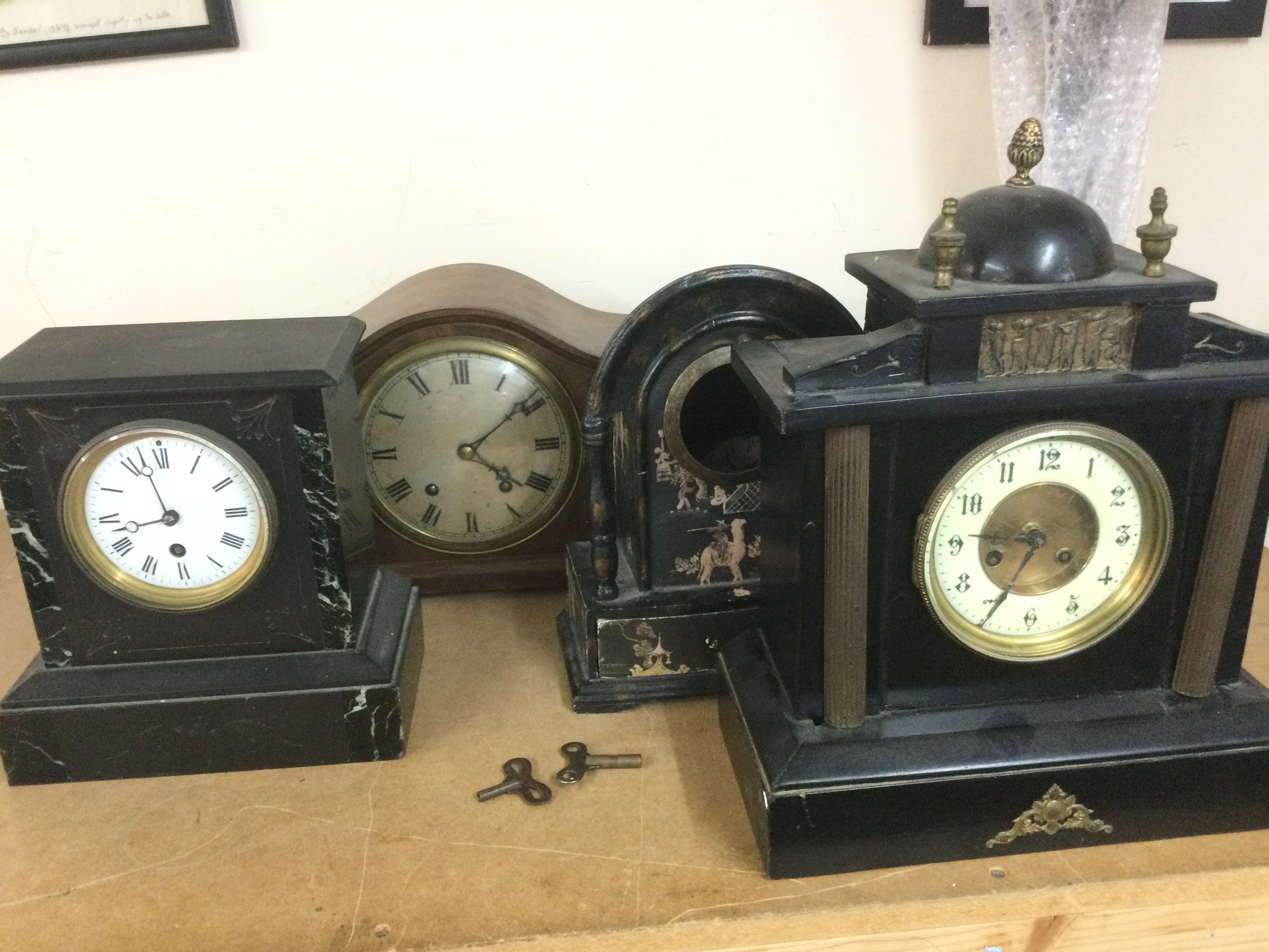 Three mantle clocks and a painted clock case (4). Shipping category D.