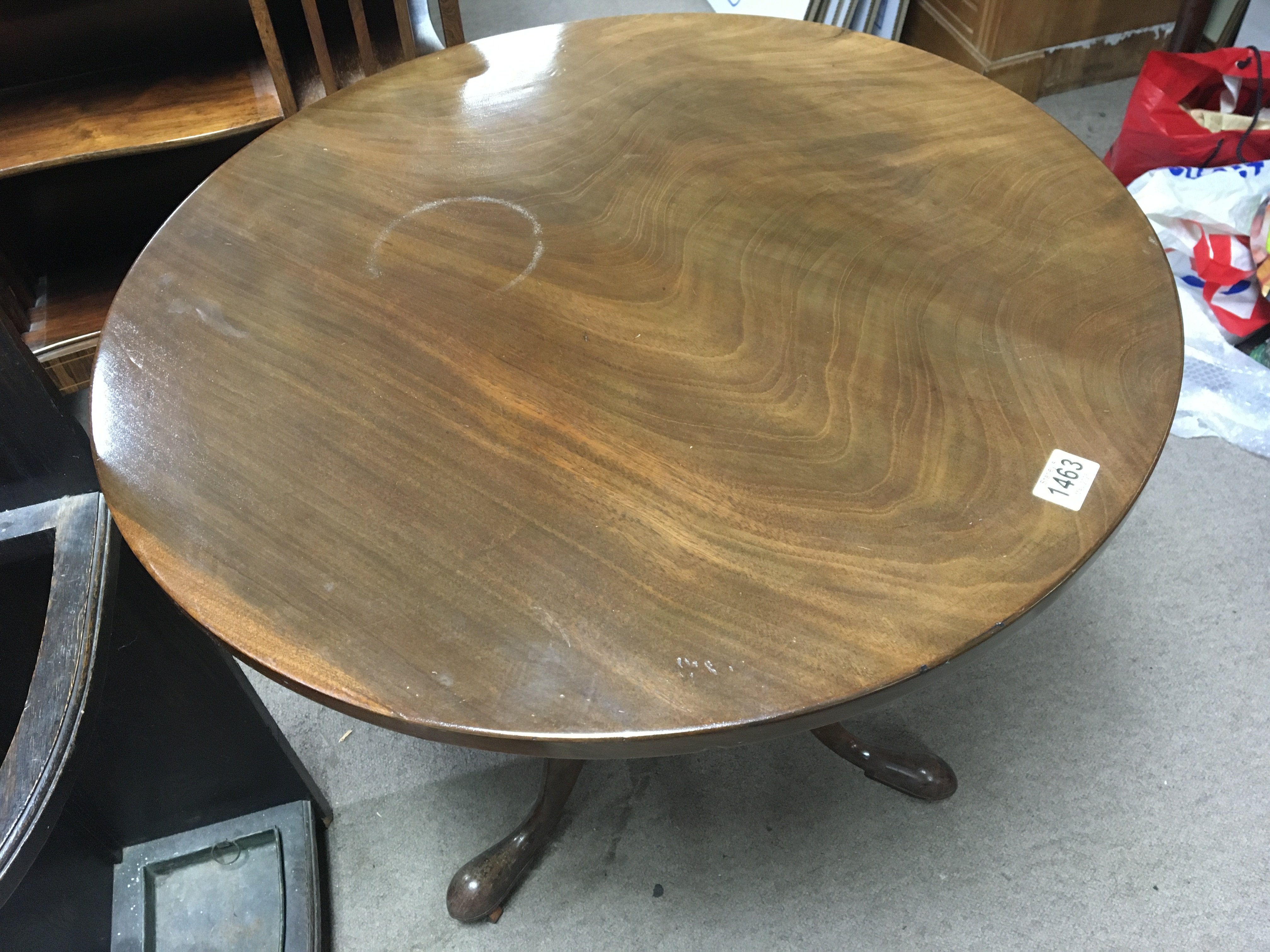 A late George III mahogany table the hinged circular top on an inlaid an turned column and splayed legs.