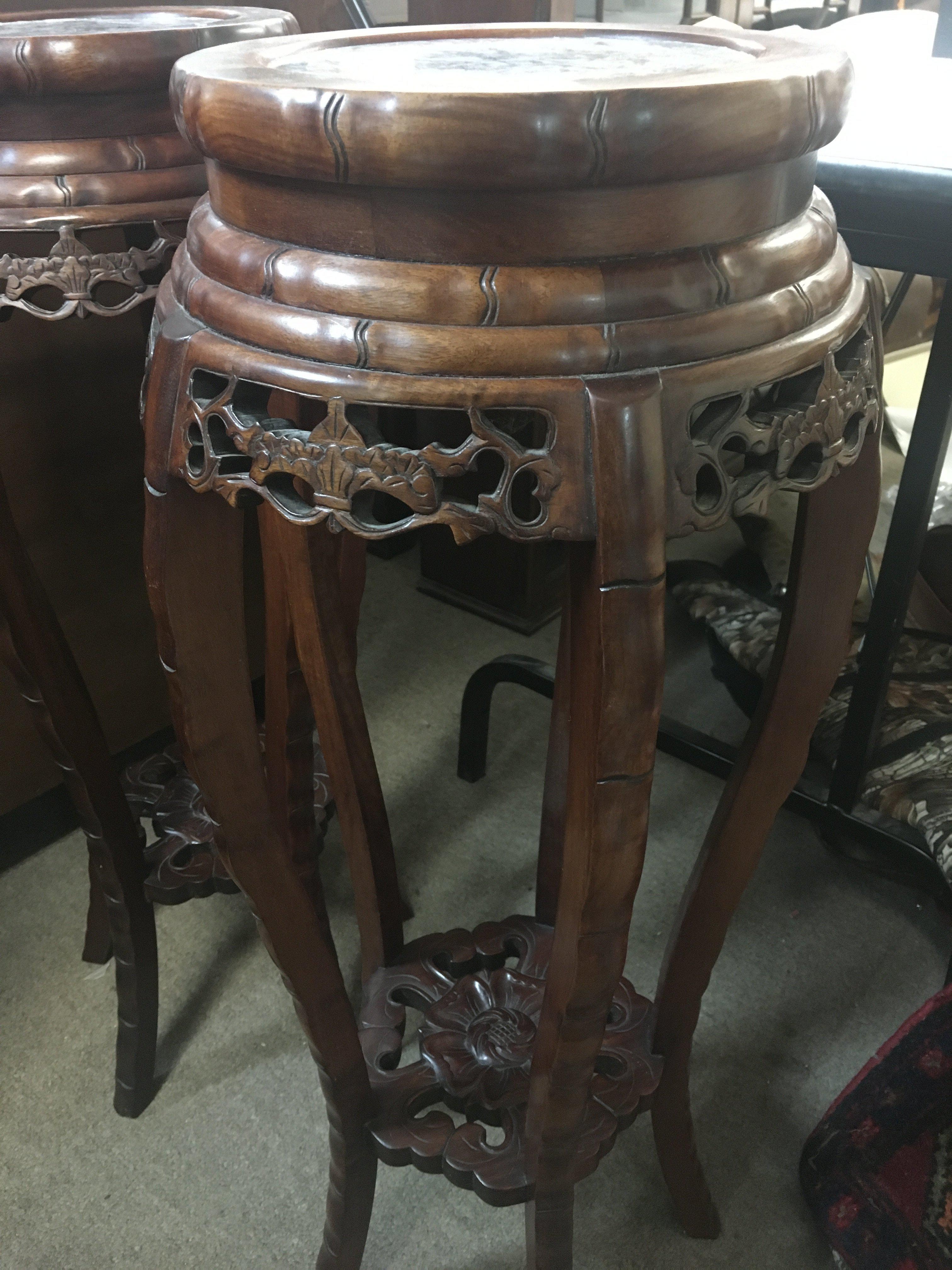 A pair of oriental wooden pedestals with marble tops, 82cm tall