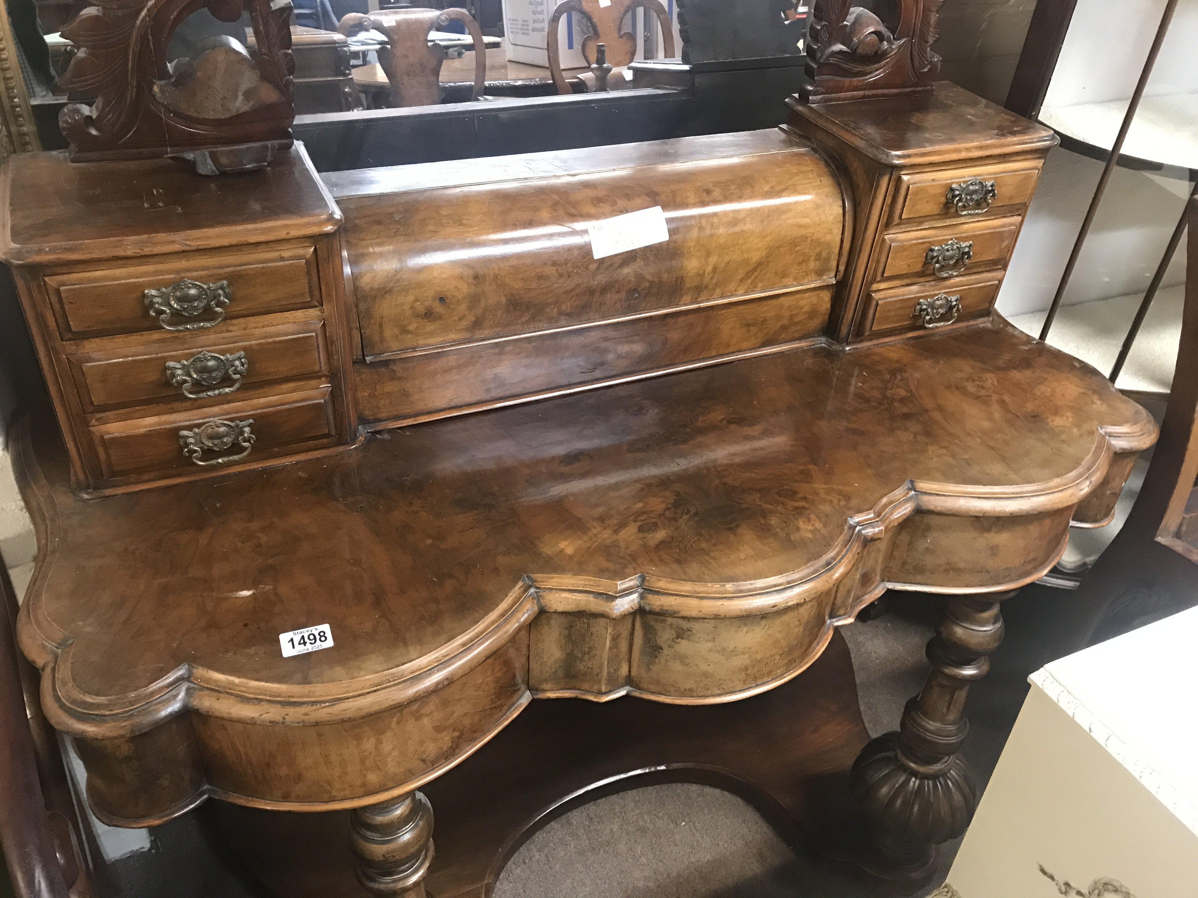 A walnut dressing table with swing mirror fitted with six small drawers.