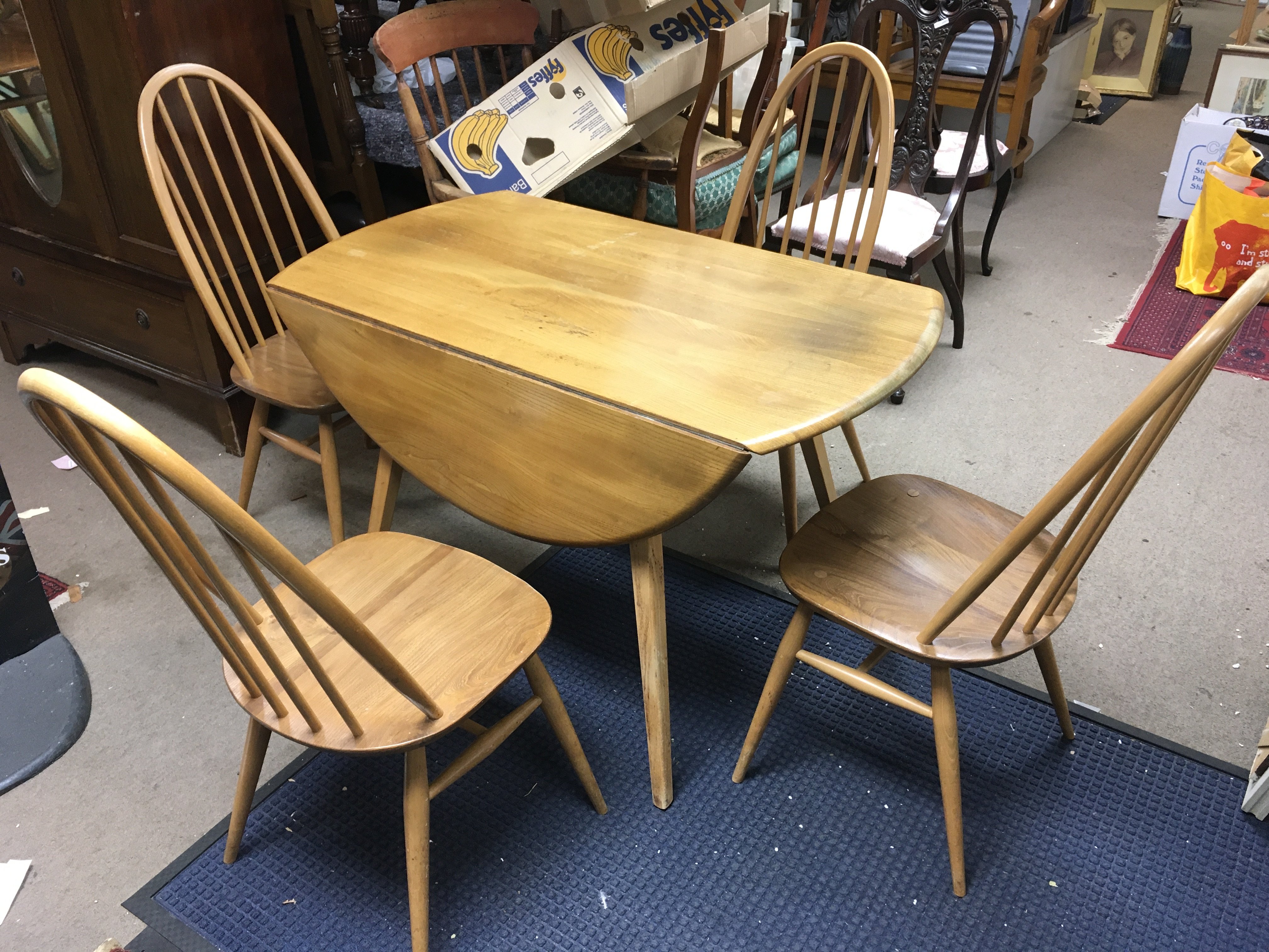 A light Ercole drop leaf table and four chairs 124cm wide 110cm long (fully extended) chairs 95cm tall