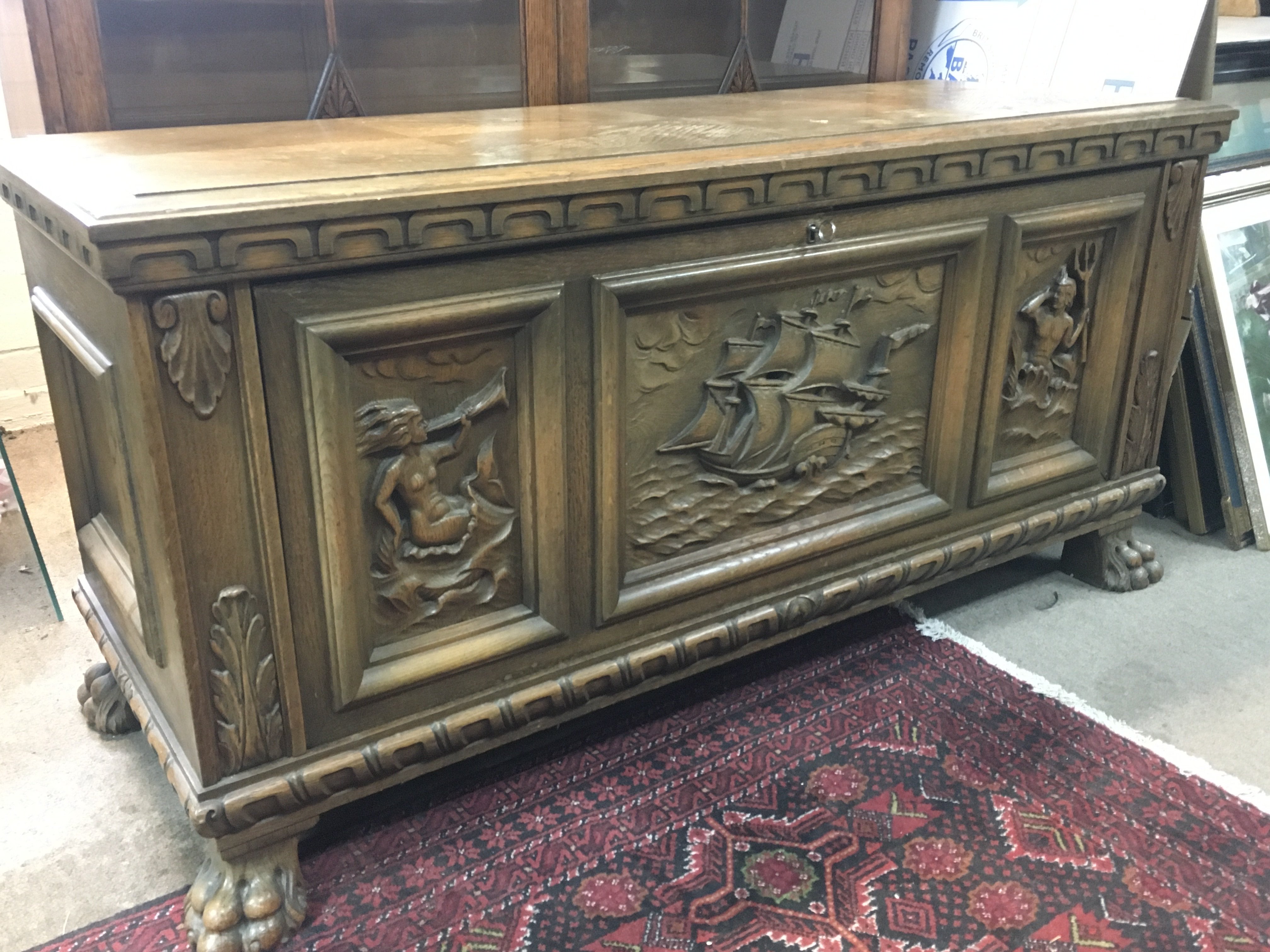 A Continental Carved Chest with ship carved design and fitted interior , dimensions 50x128x62cm