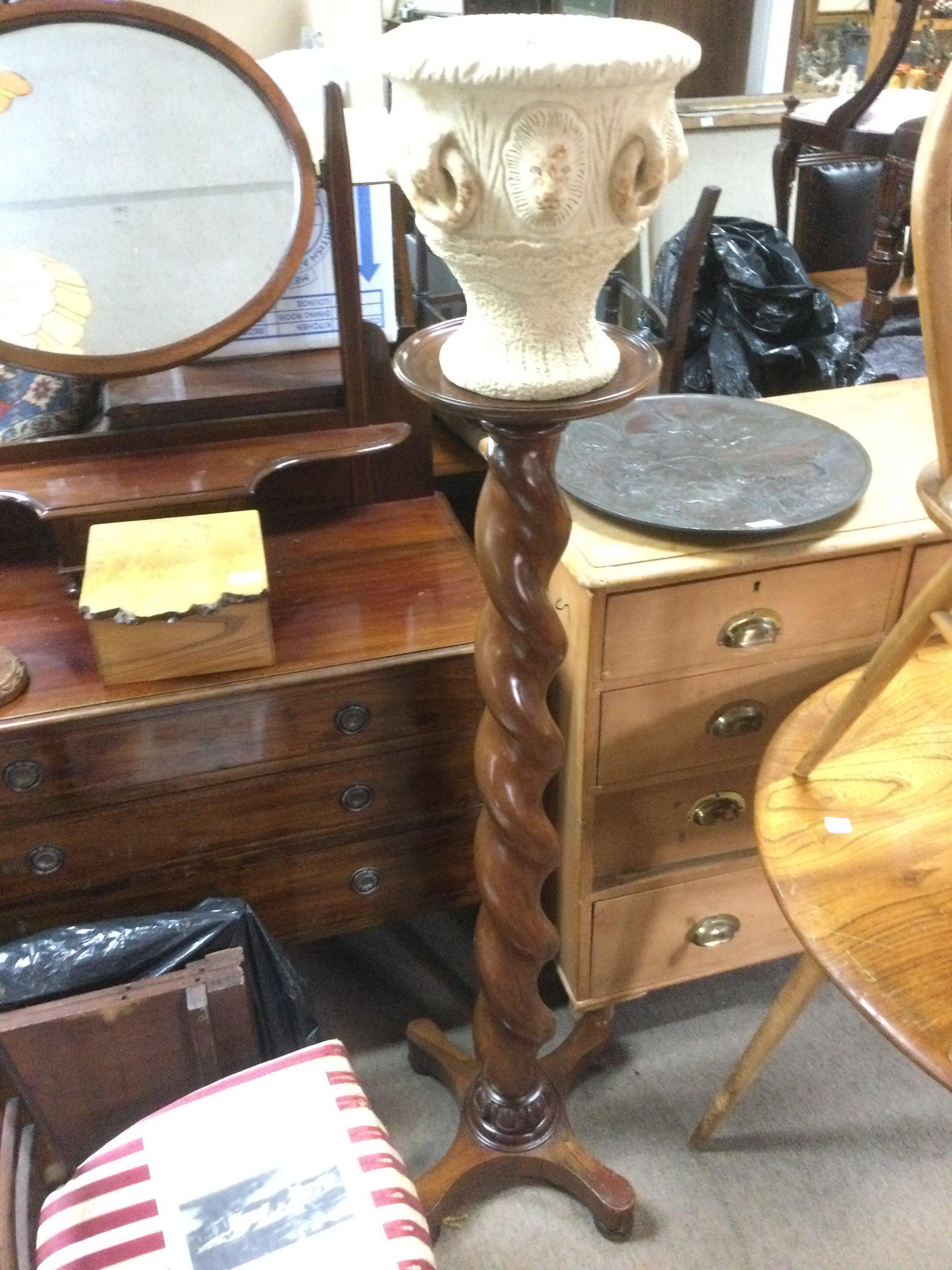 A mahogany plant stand with barley twist support and a Cotswold Studio pottery vase (2). Shipping category D.