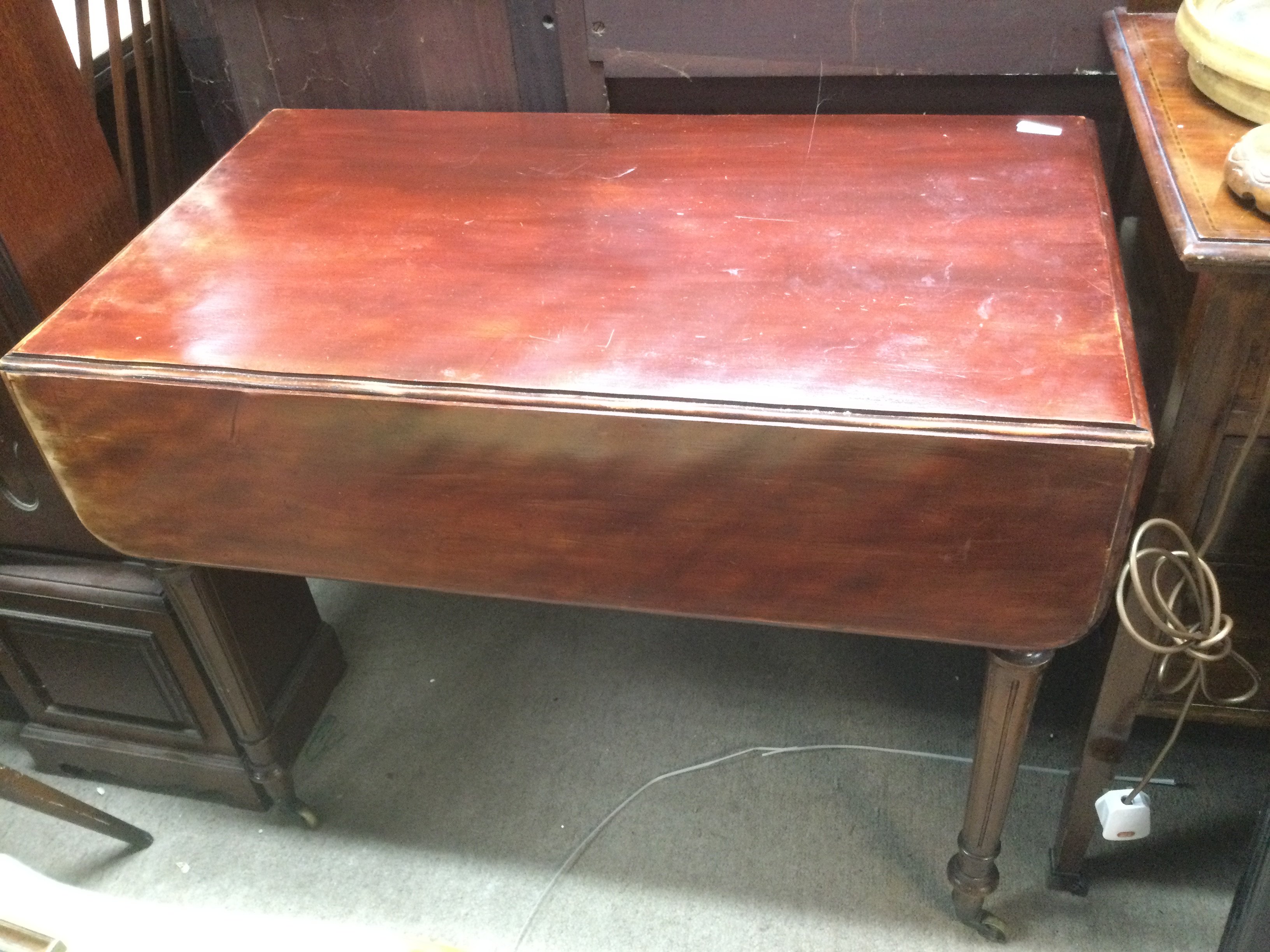 A drop leaf table with fluted legs, approx 52cm (when closed), 90cm x 70cm. Shipping category D.