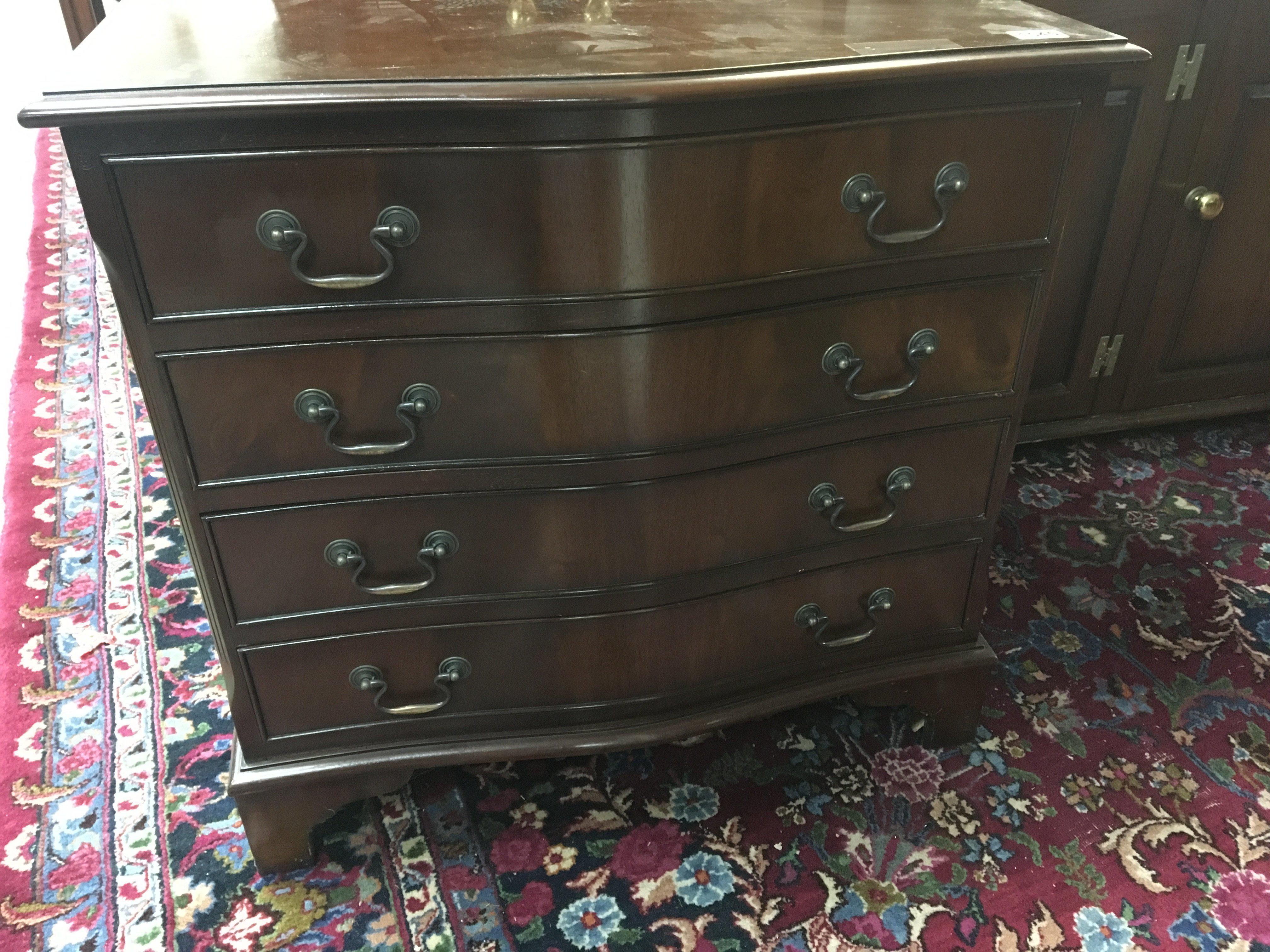 A mahogany sperentine chest of drawers fitted with four long drawers.