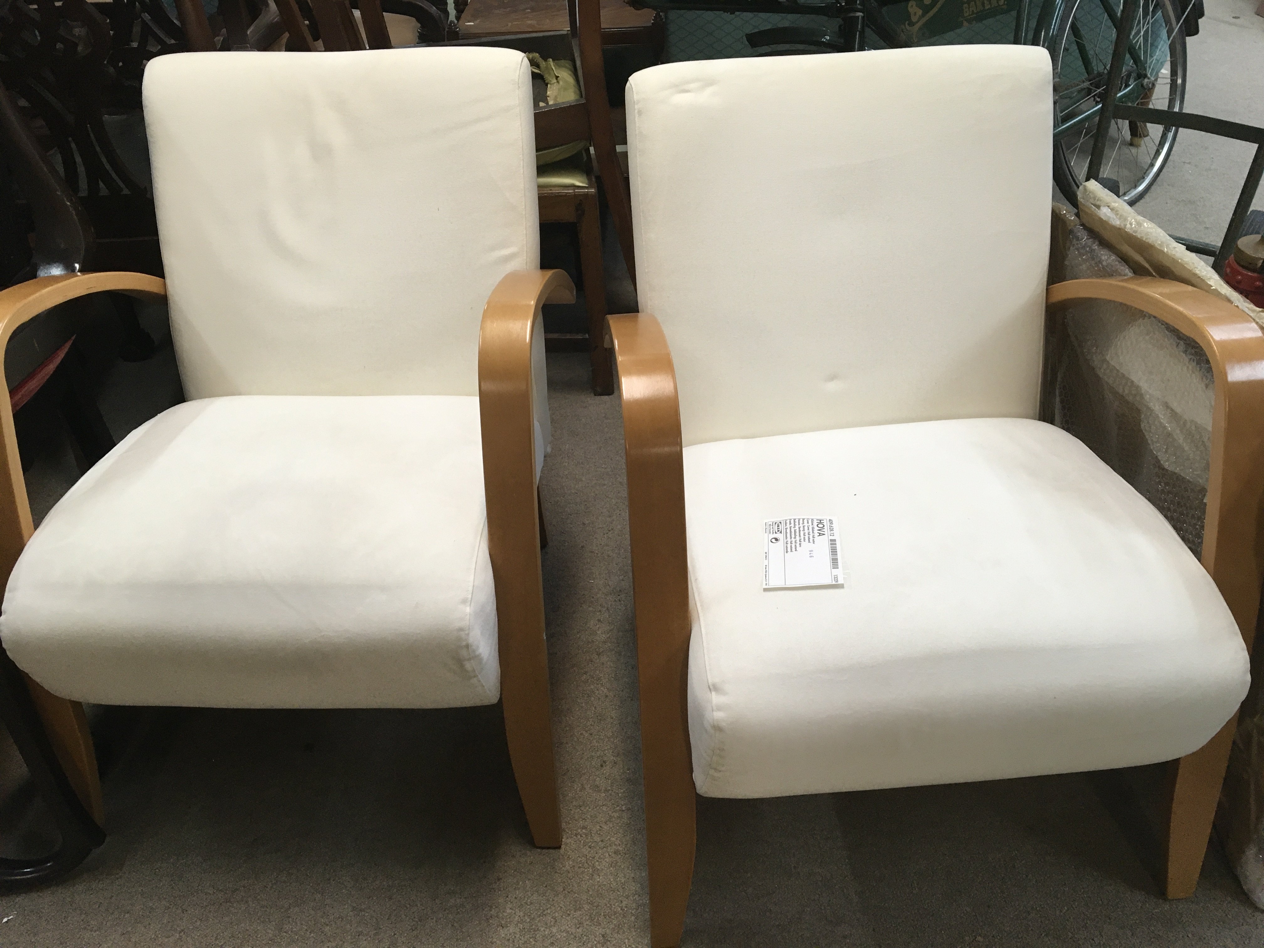 A pair of modern design open armchairs.