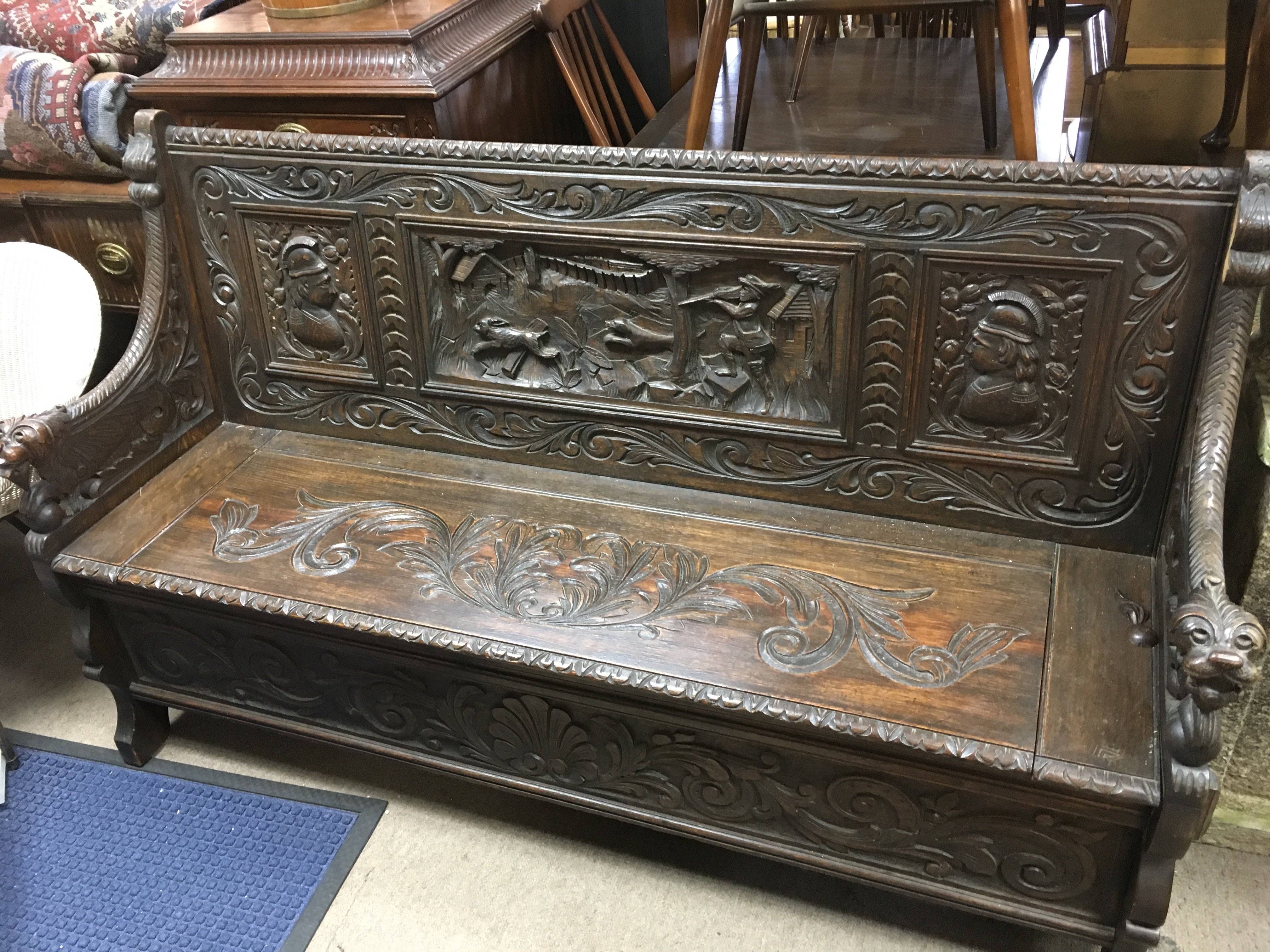 A carved oak hall settle , 155cm wide 95cm tall