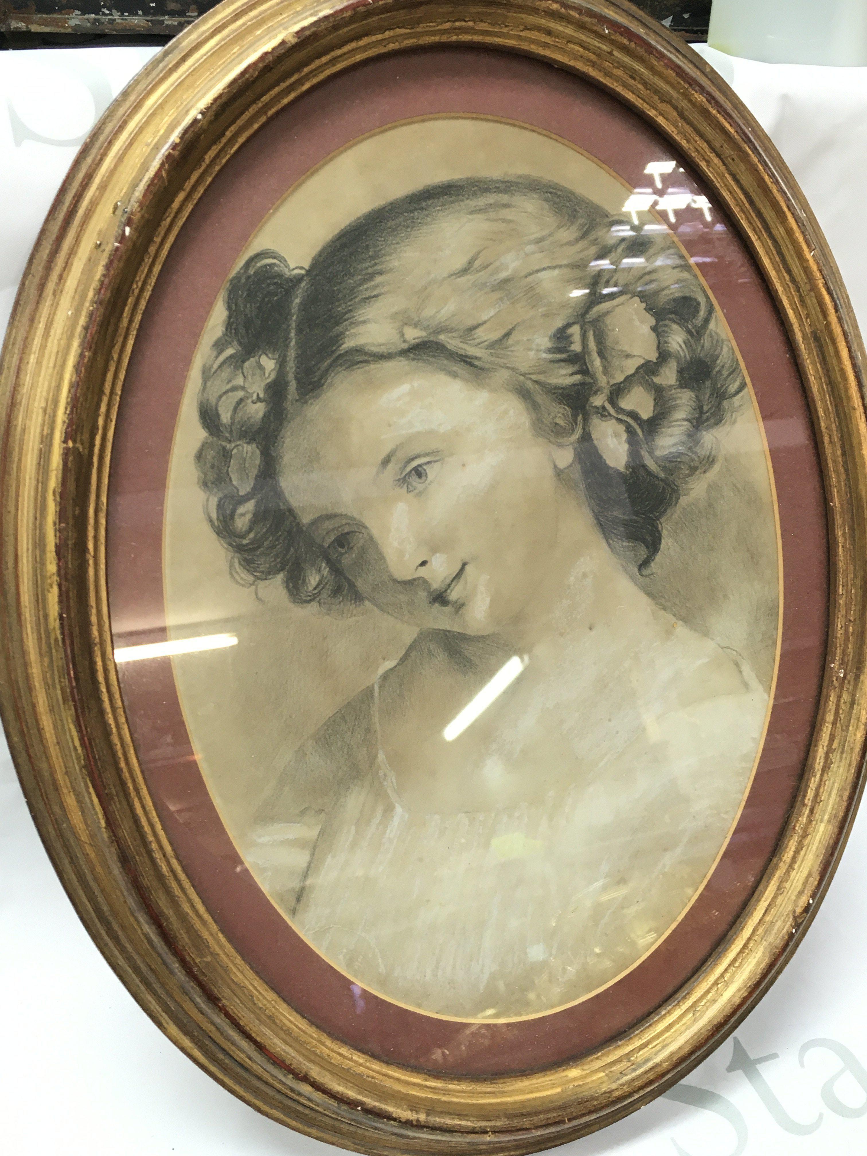 An early 20th century framed chalk and charcoal sketch of a woman . 47cm tall 37cm wide. This lot cannot be posted