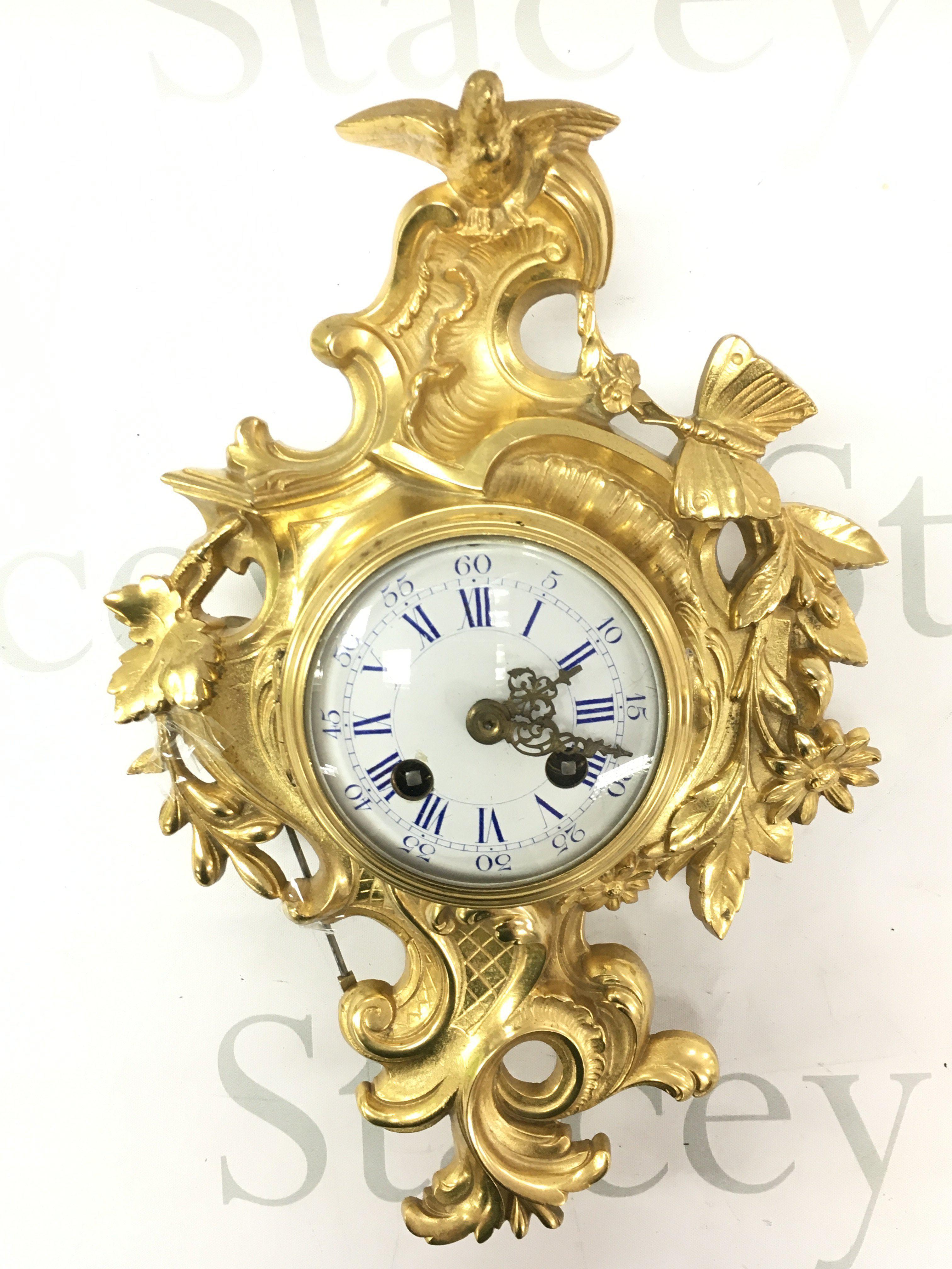 A 19th century French Ormolu cased wall clock by Japy Freres decorated with flowers, leaves a butterfly and bird surmount with eight day twin train brass movement.