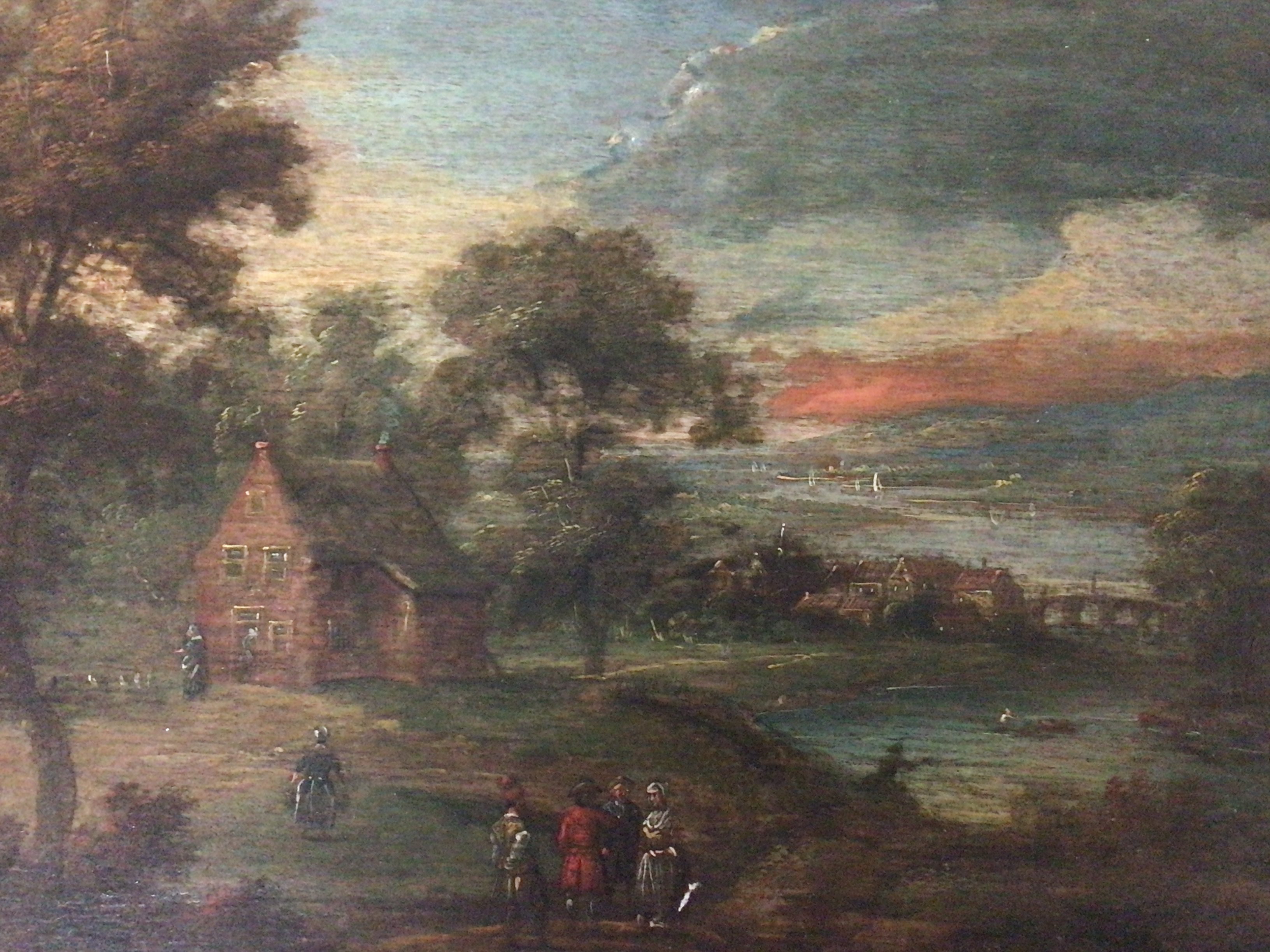 A pair of oil paintings on panel North European possibly late 17th century and of the period depicting landscapes with socialising figures and buildings unsigned and unattributed. Restored reframed. 43x37cm including frame size.
