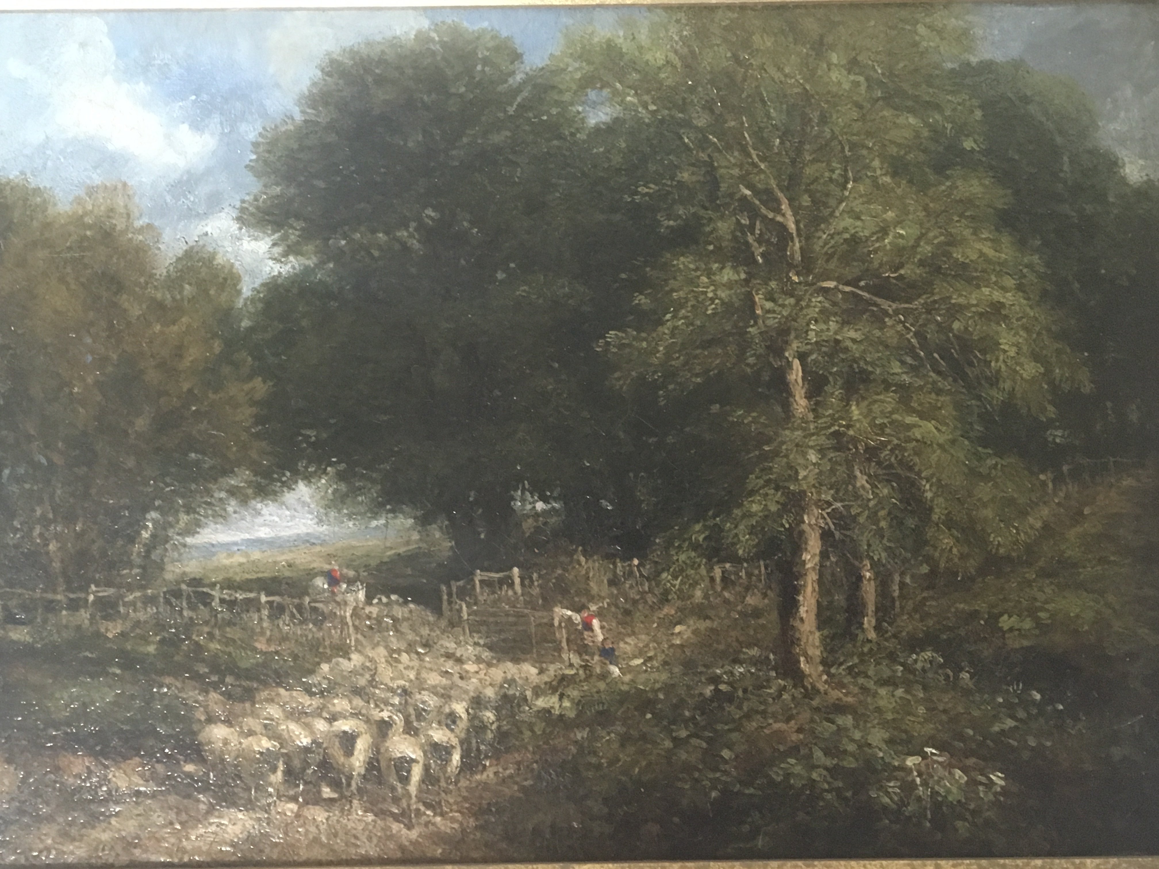 A 19th century oil painting on panel depicting a rural scene the gathering and hearing of a flock of sheep with figures unsigned attributed to John Linnell (1792-1882) the reverse with inscription restored and reframed. 52x41cm