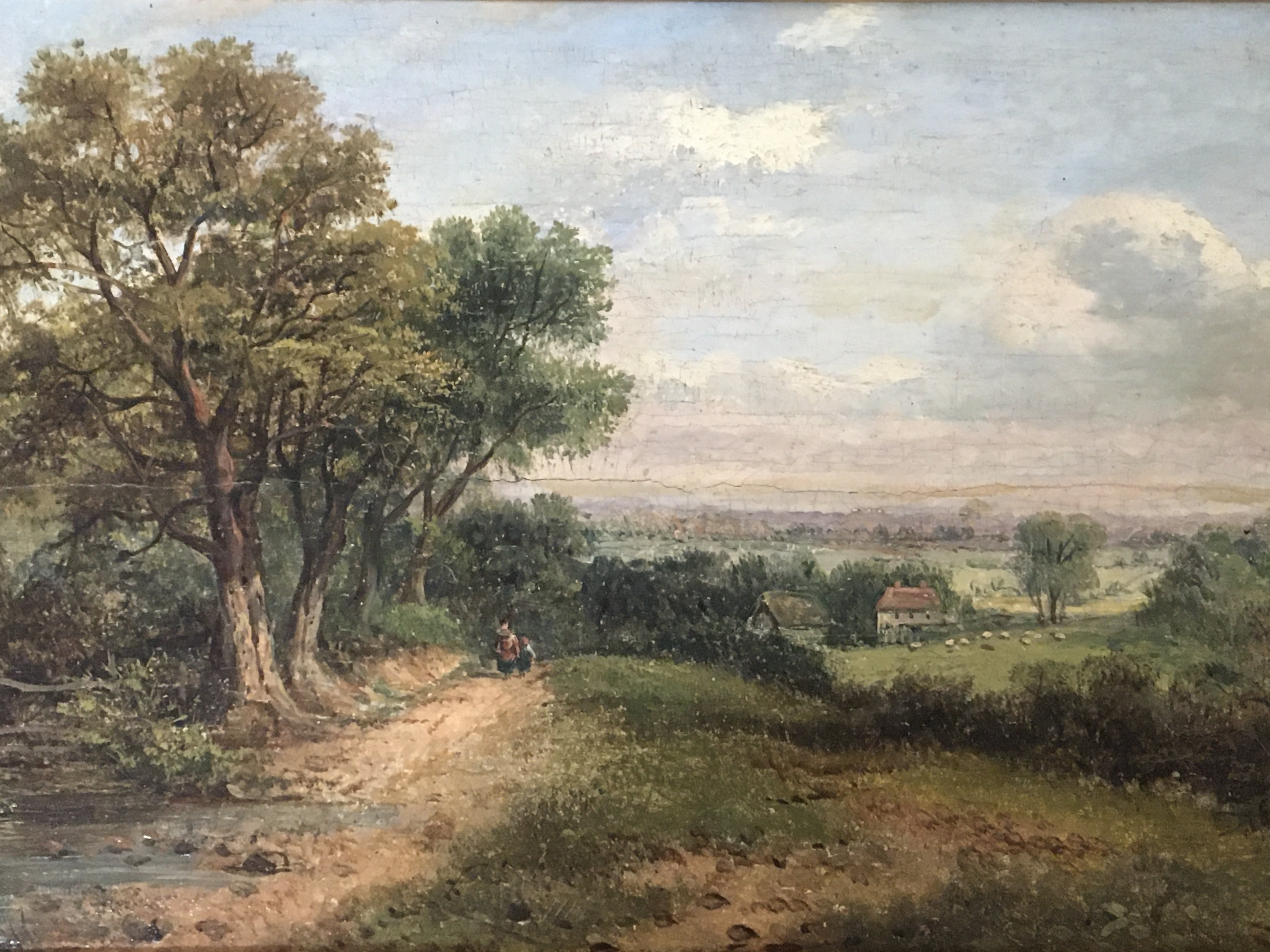 A mid 19th century oil painting on panel a British rural landscape with figures on a path and building beyond. Signed lower left Indistinctly and dated 1848. See image. 54x38cm