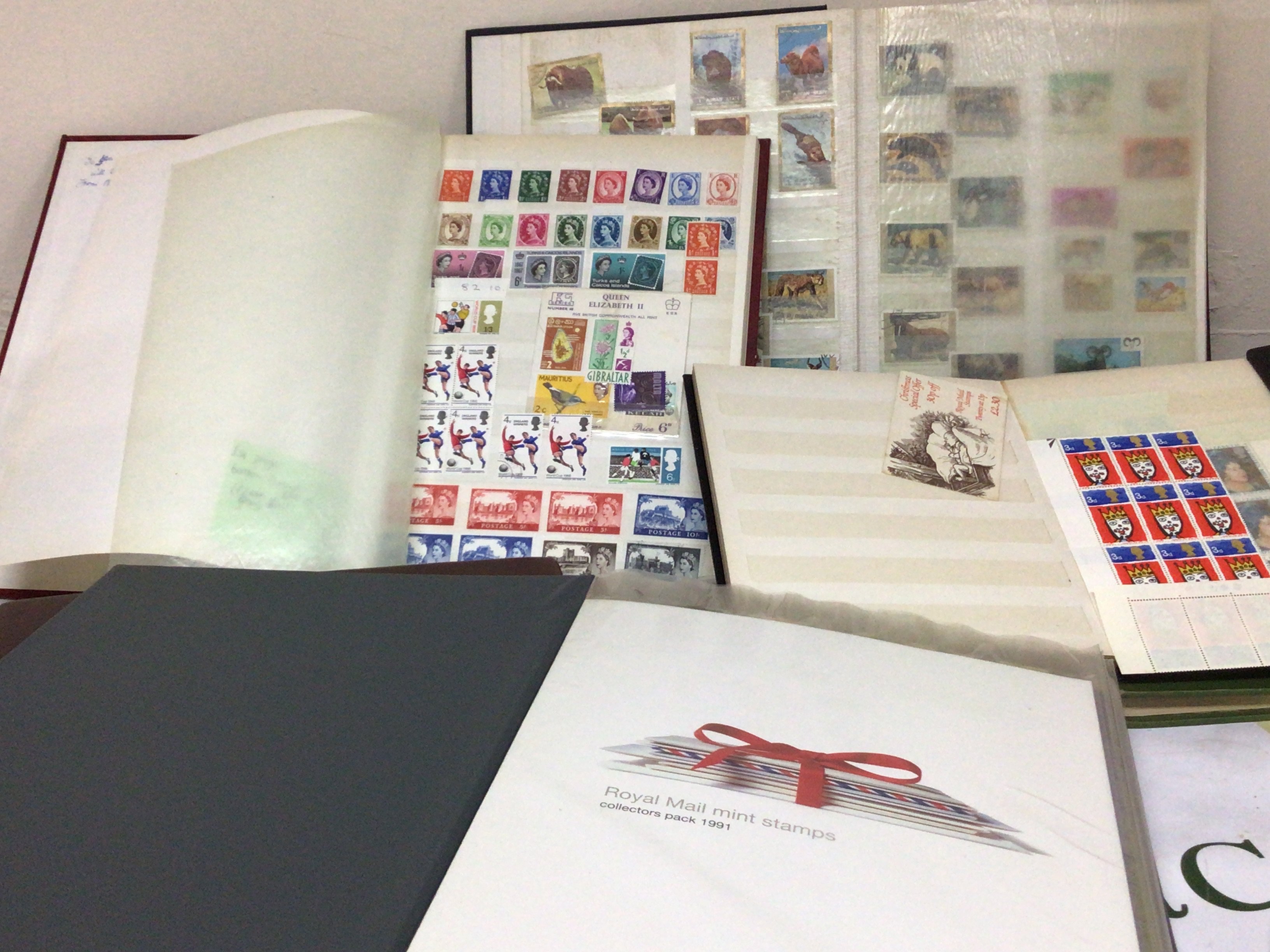 An album containing Royal Mail Year Packs 1991-2002 not complete an album of presentation packs and other stamp albums British and world stamps used and unused.