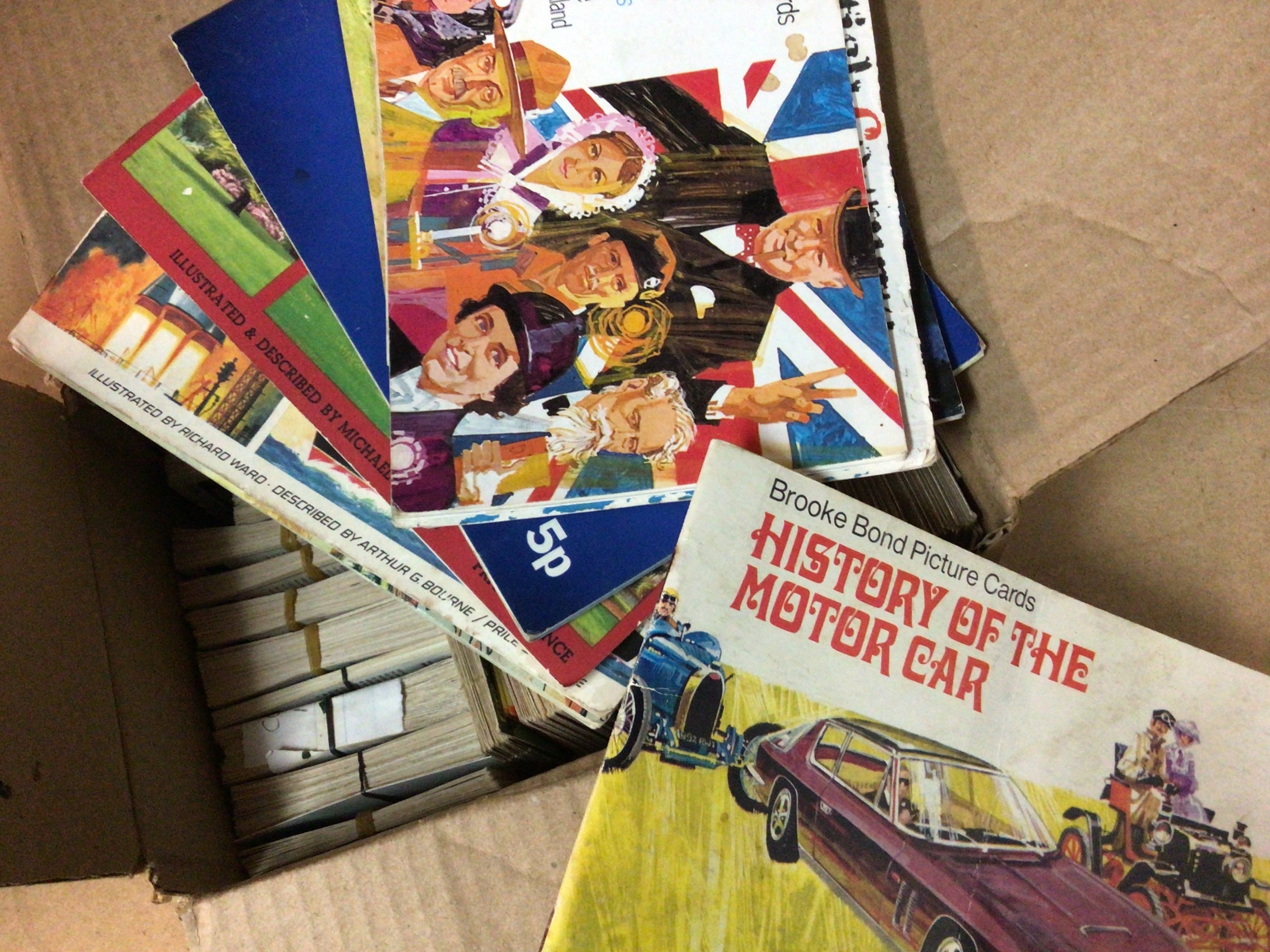 A box containing cigarette cards various including History of The Motor Car