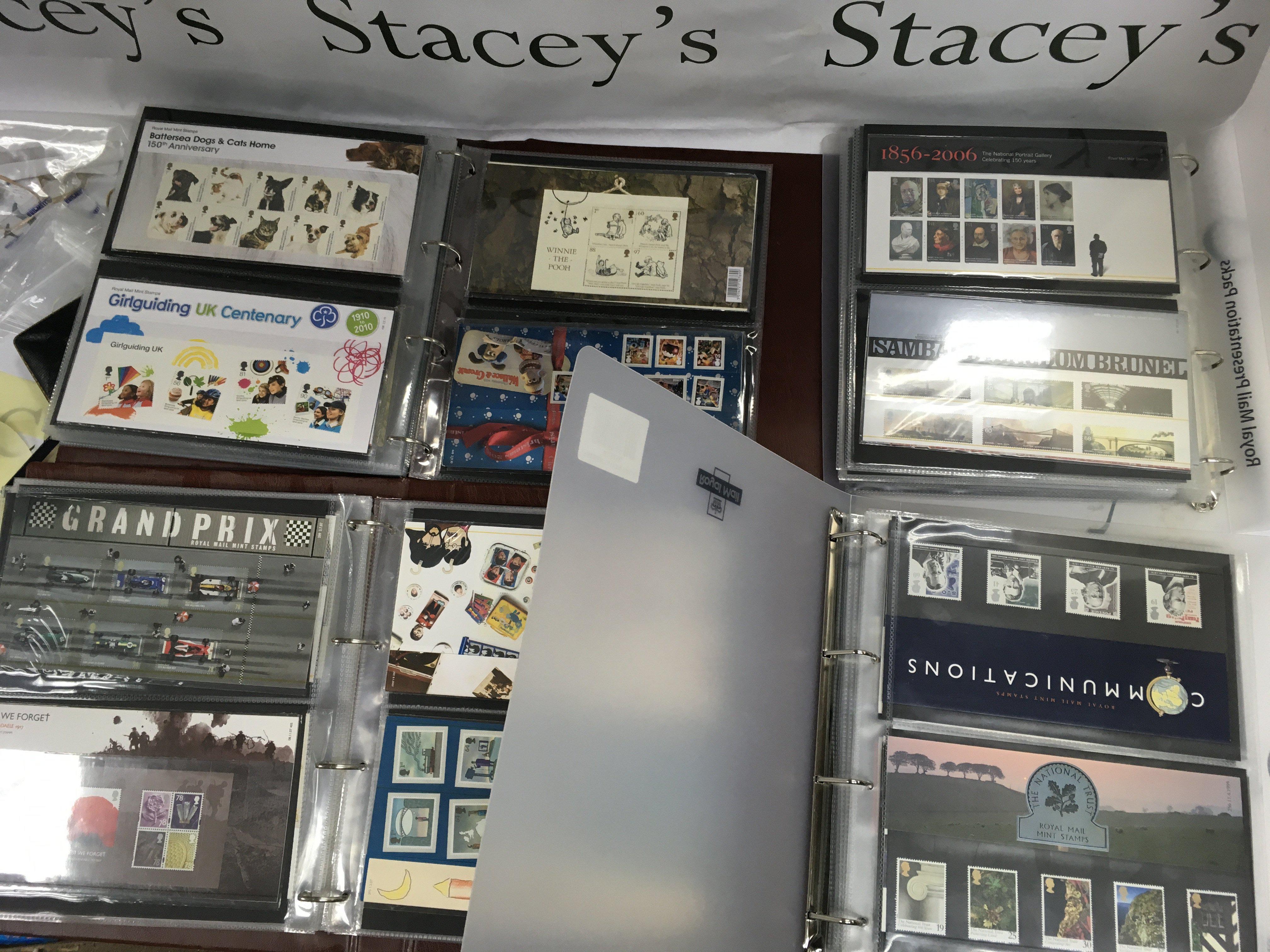 Four albums containing Royal Mail presentation mint stamp packs .