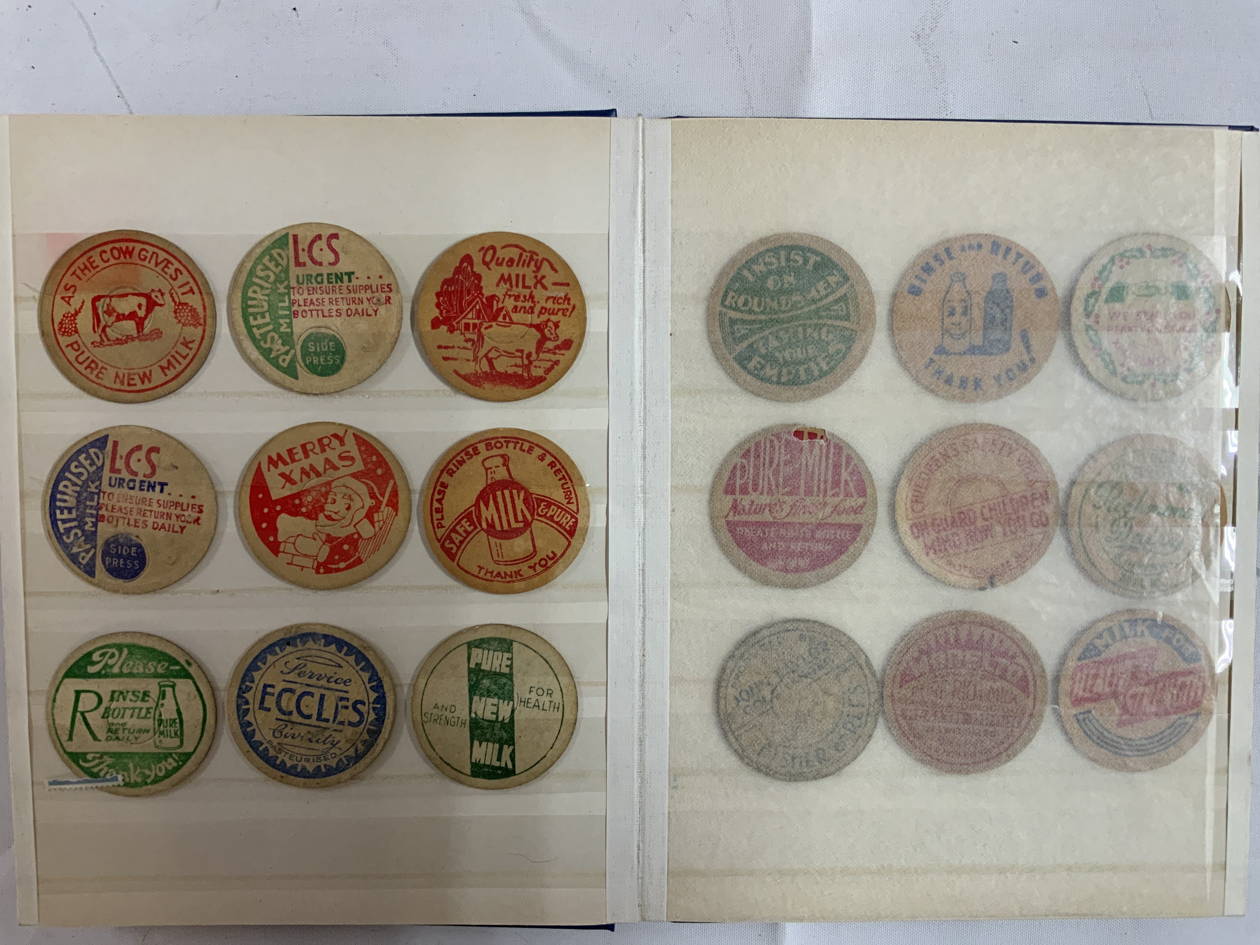 A collection of 68 card milk bottle advertising tops. (B)
